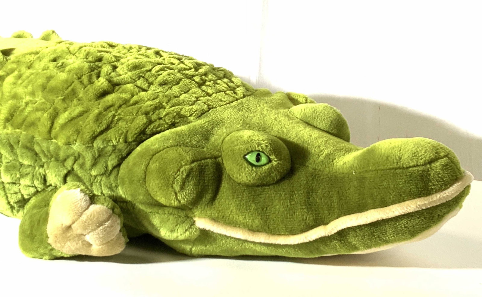 MELISSA & DOUG Oversized Plush Alligator: Plush green alligator stuffed toy. Oversized, Beige belly and footpads. Green eyes. One mild stain on alligator’s back. Tags read: Melissa and Doug, 100% Polyester Fiber, CF12094, Alligator #2173, A