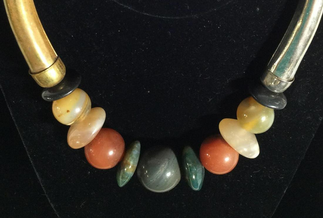 Natural Stone Bead Bar Collar Necklace: Large round stone beads, mix of quartz - carnelian And Agate. Largest 20 mm bead. Sides of Necklace are metal, one brass tone the other silver tone. Hook and loop closure. Wear to metal. App 5 in widt