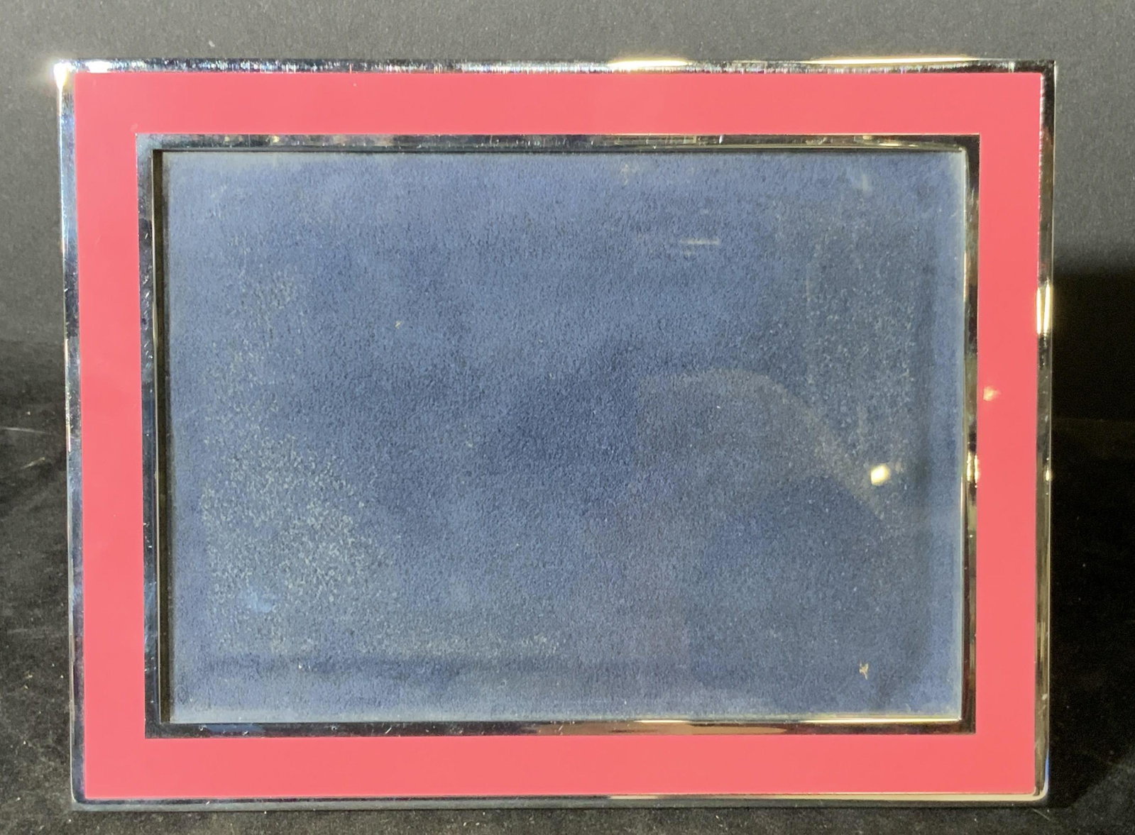 Signed KATE SPADE Lenox Pink & Navy Picture Frame: Glass picture frame with soft textile navy backing and frame stand. Square shaped with pink edges. Signed underside reads: Kate Spade, New York, Lenox. Sides are mirrored, hardware silver toned. Appro