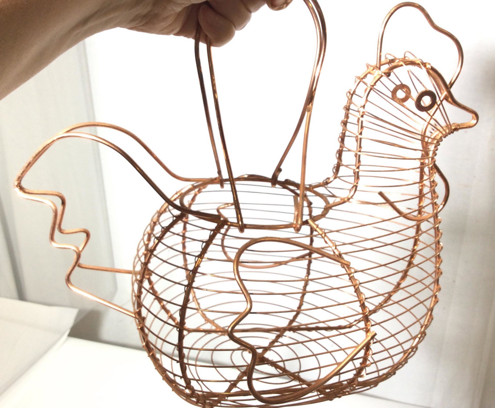 Copper Hen Figural Wire Egg Basket: Wire basket with carry handles, also can be used for hanging. Use for counter storage, take to farmer’s market, Use as a kitchen table centerpiece. 12 in long, 15 in wide, 10 in tall. Decorative Cop