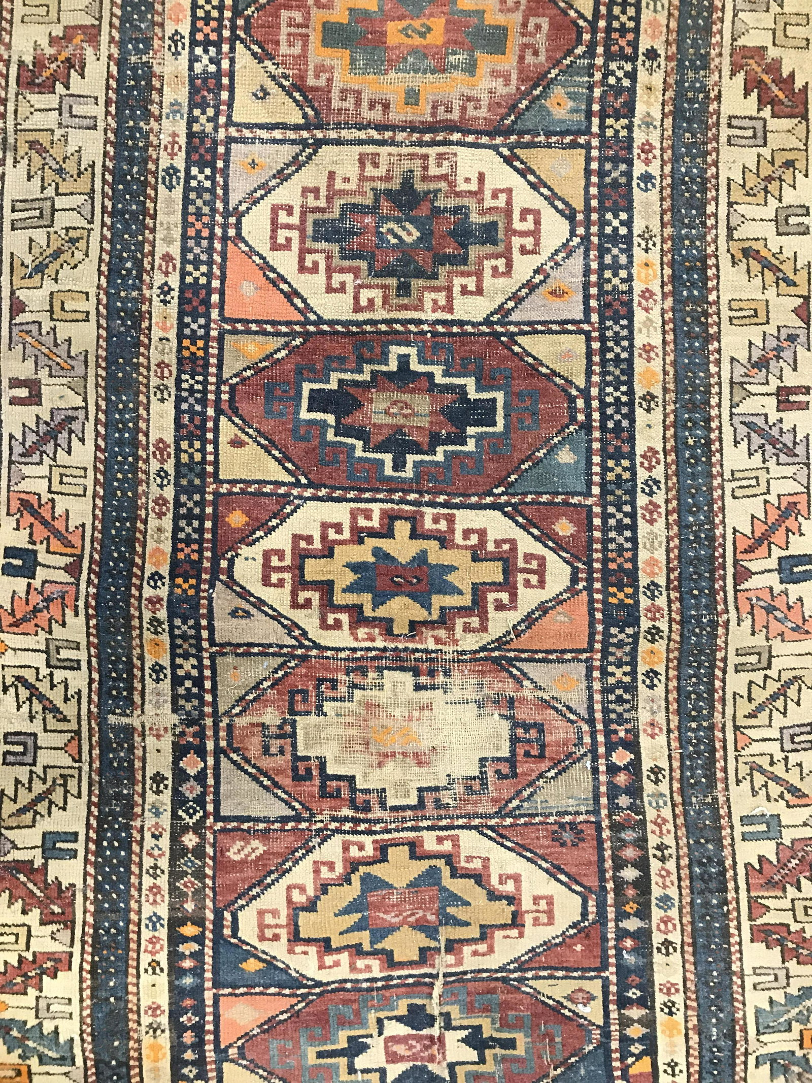 Antique Handmade Turkish Wool Rug: Rug is wool and handmade. Piece is antique. Rug has intricate multi toned geometric detail. Rug has small fringes. Piece measures approximately 57 inches long 39 inches wide. Rug, carpet, area rug, wo
