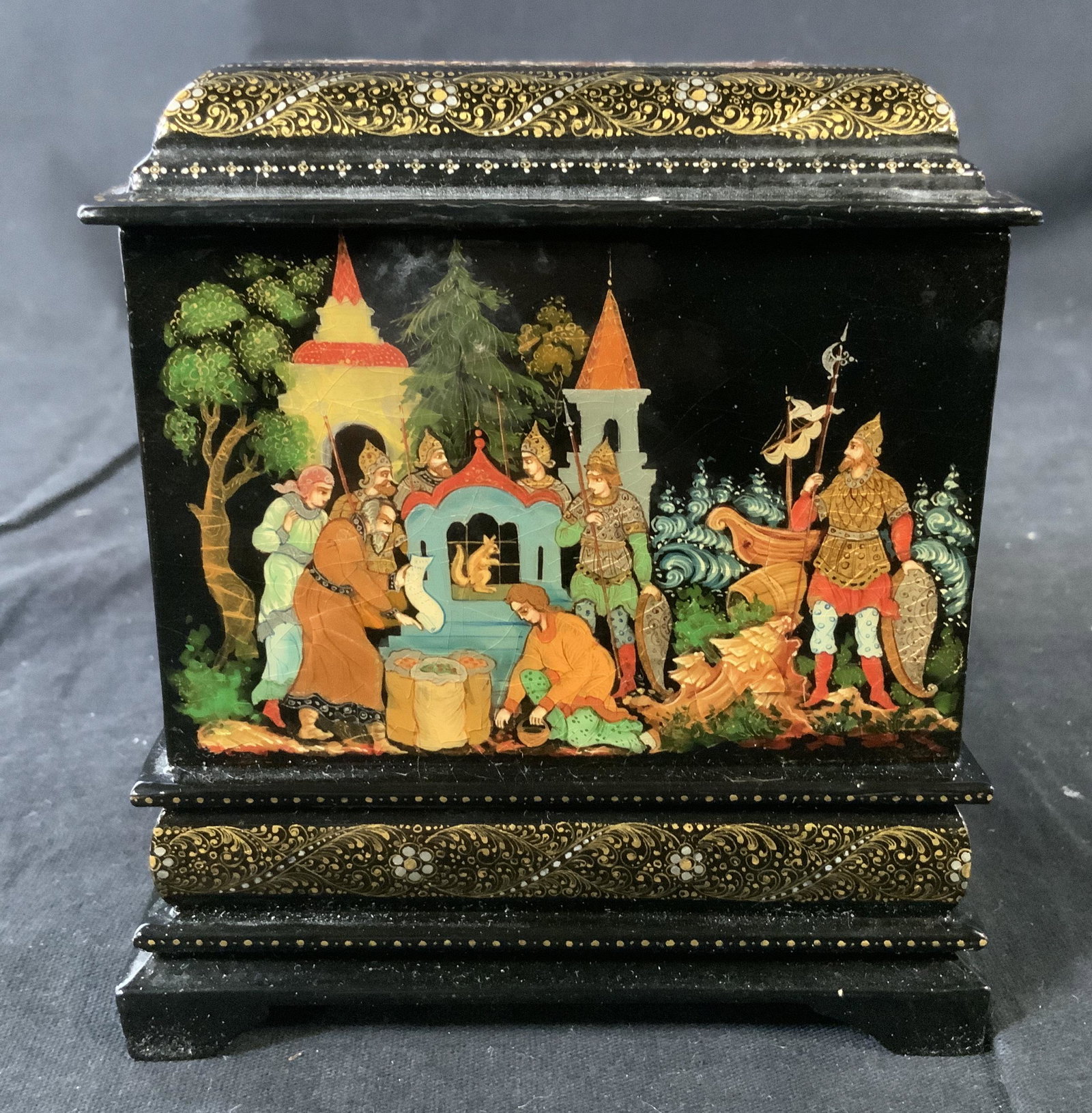 Russian Lacquered Wooden Box: Russian Lacquered Wooden Box, inscription to reverse reads ‘Box The Tale of Tsar Saltan Tempera, gold paint, and lacquered on Papier mache min Palekh 1994 Juakin PJ’, hand painted scenes from a Ru