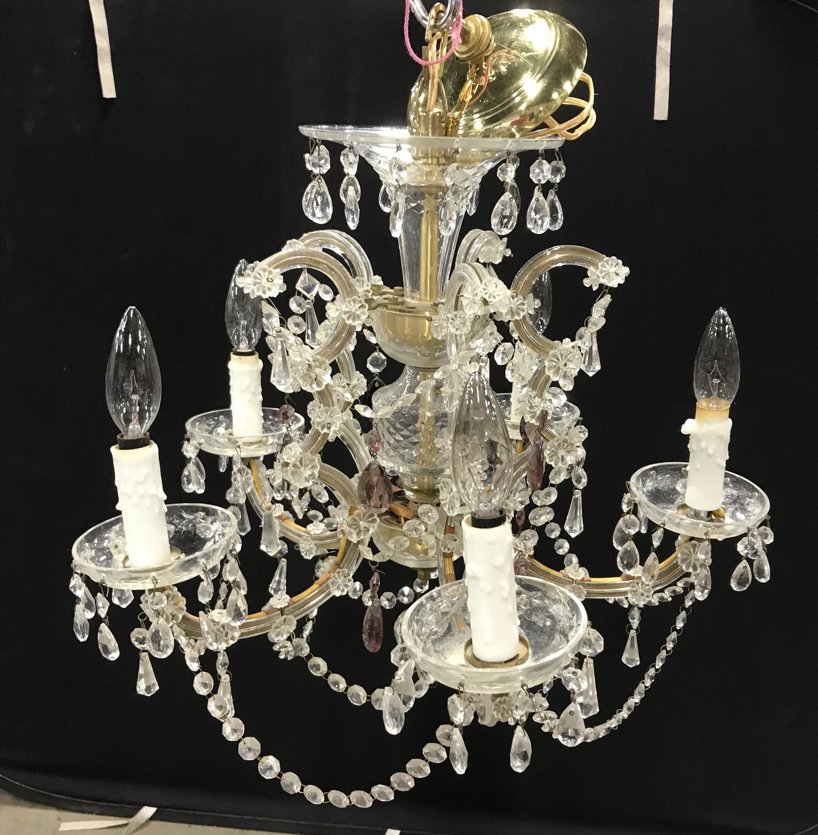 Vintage Brass & Crystal Chandelier: Petite brass and crystal chandelier With amethyst style drops, possibly antique. Includes additional Crystal Baubachs. Bulb socket sheathes are wax and board. Measures approx 14 inches H, and 19 inche