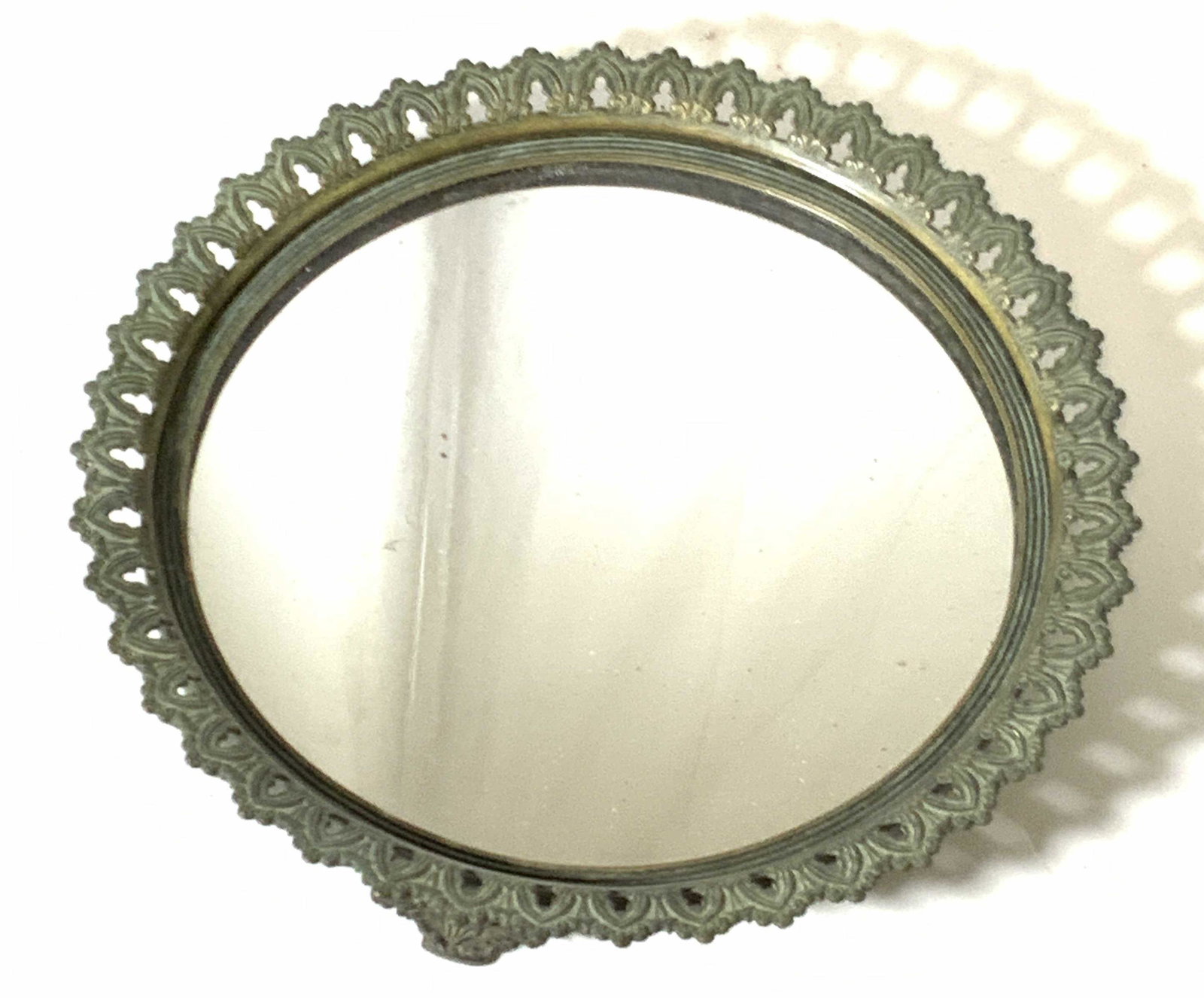 Antique Bronze Mirrored Vanity Tray: Footed bronze vanity tray with mirror surface. Pierced metal trimming. Victorian style. Approx. 2 in. height. Approx. diameter 11 in. Collectible antiques, vanity tray, mirror, mirrored tray, Victoria