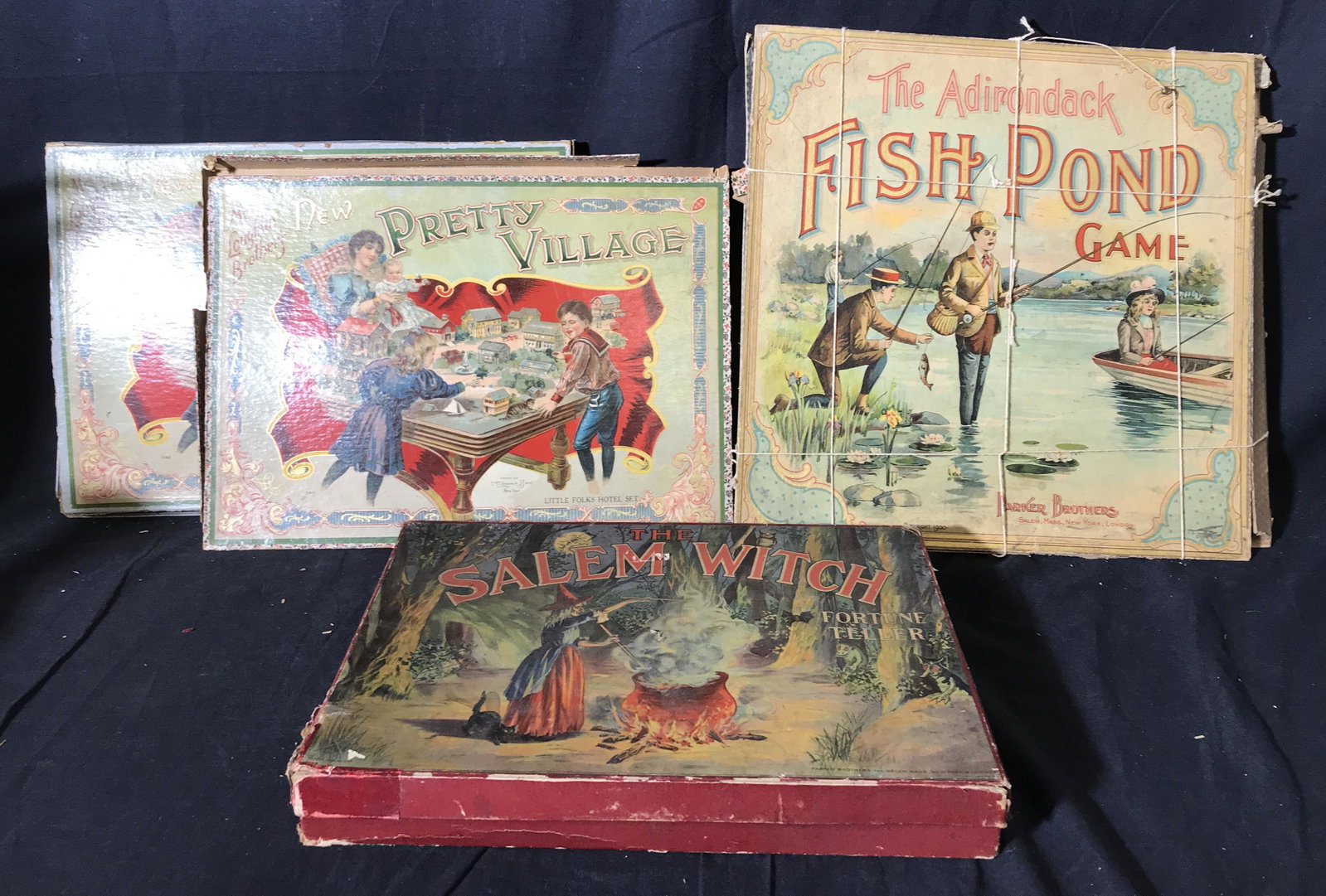 Lot 4 Antique Tabletop Games: Lot 4 antique tabletop games. Games include THE ADIRONDACK FISH POND GAME, THE SALEM WITCH FORTUNE TELLER, and two copies of NEW PRETTY VILLAGE. Games are by MCLOUGHLIN BROS & PARKER BROS. Contents ha