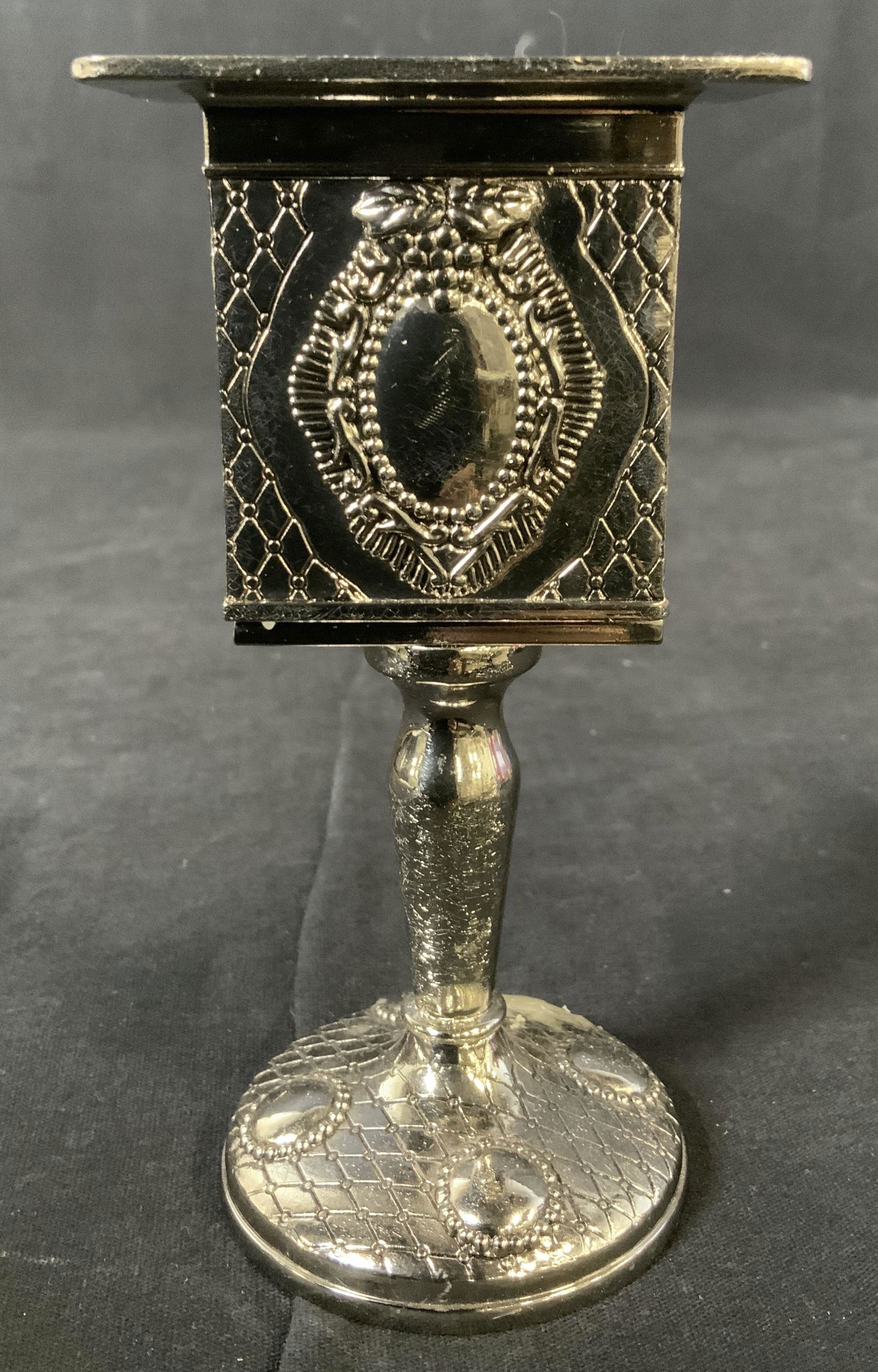 Silver Toned Candlestick: Silver Toned Candlestick, no apparent inscriptions or stamps, silver toned metal, measures 5 1/4 x 2 3/4 inches, some wax remaining from previous usage but overall in good condition, Candlestick, cand