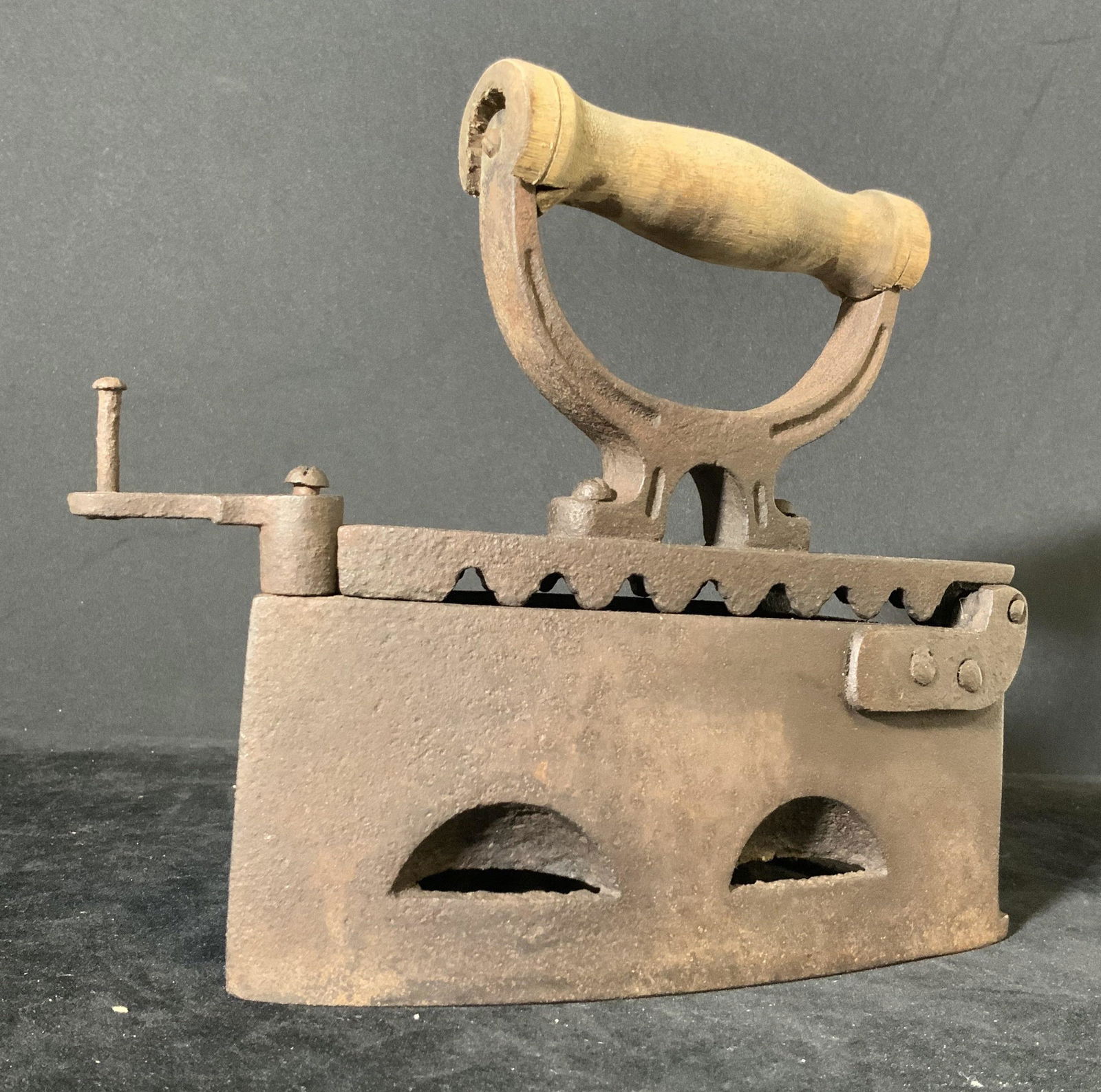 Antique Cast Iron & Wood Handcrafted Iron: Age approx. mid to late 1800s. Wooden handle, cast iron base. Iron has a hinged lid. In order to heat the iron up, people used to add in hot coals. Approx. 8 x 8 in. Antique collectibles, antique iron