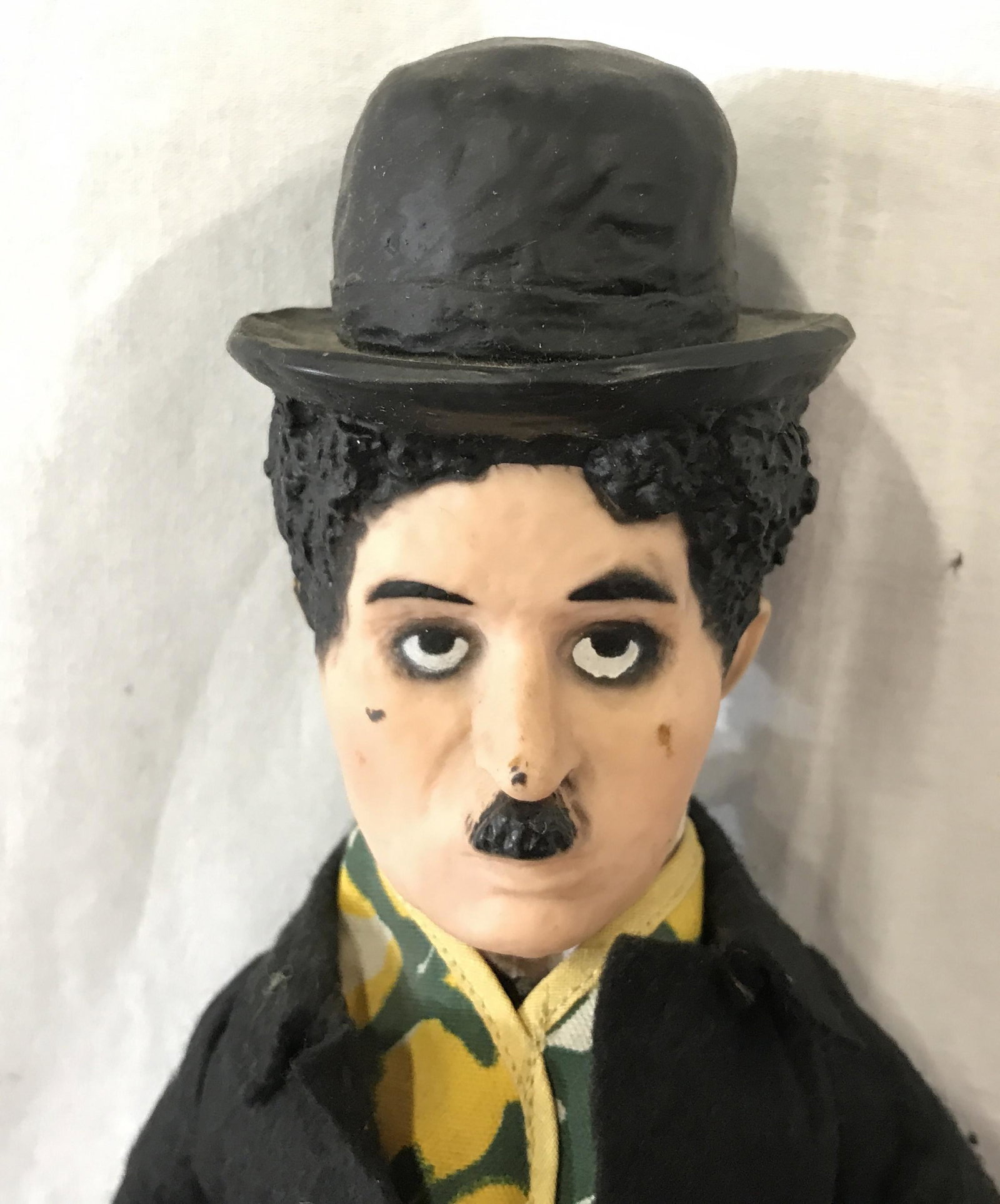 Vintage CHARLIE CHAPLIN Doll: Vintage, possibly antique, Charlie Chaplin doll. Doll is hand painted, feet, hands, and head are crafted from a composite material. Measures approx 19 inches H, 6.5 inches W. Cane is crafted from wood