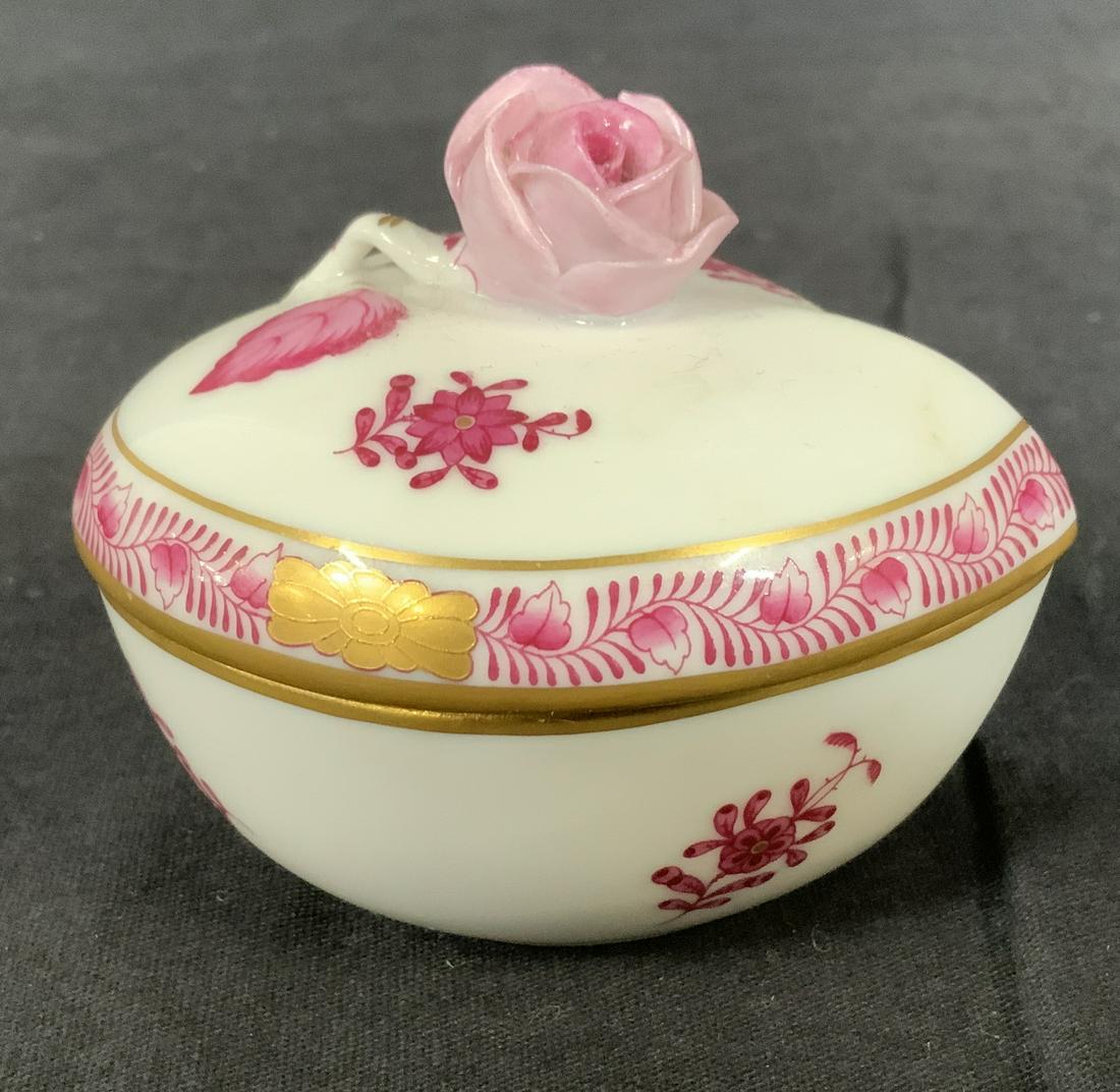 HEREND Hungary Heart Shaped Porcelain Trinket Box: Herend Heart Shaped Porcelain Trinket Box, stamp to base reads ‘Herend Hungary Hand painted G005 0 05/AP GA’, floral design with rose shaped handle, measures 2 1/2 inches tall x 3 1/8 inches at wi