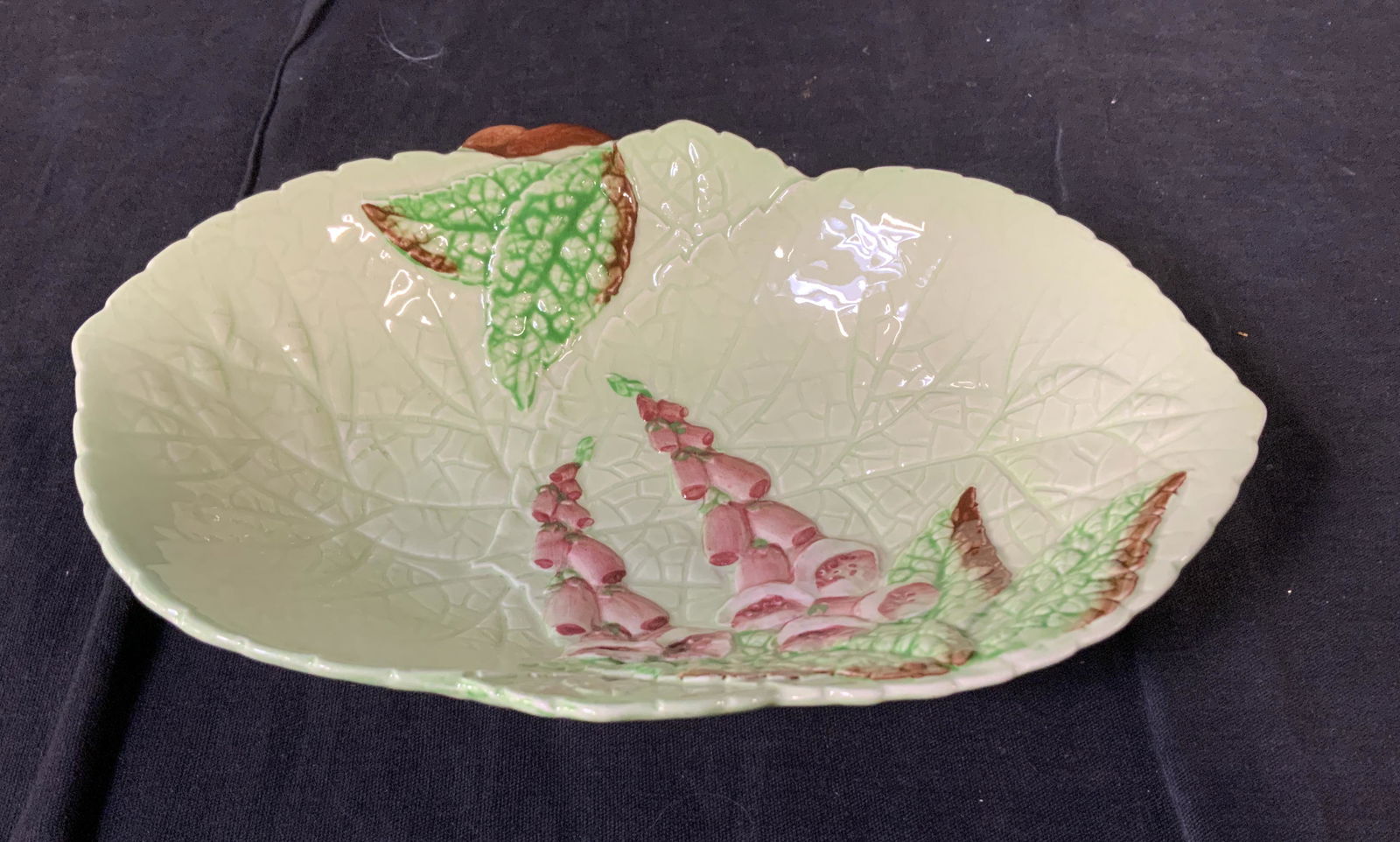 CARLTON WARE Leaf Shaped Majolica Bowl, England: Carlton Ware Leaf Shaped Majolica Bowl, stamp to base reads ‘Carltonware Made in England Trademark Registered Australian Design Registration Applied’, has flower design, measures 1 7/8 inches tall