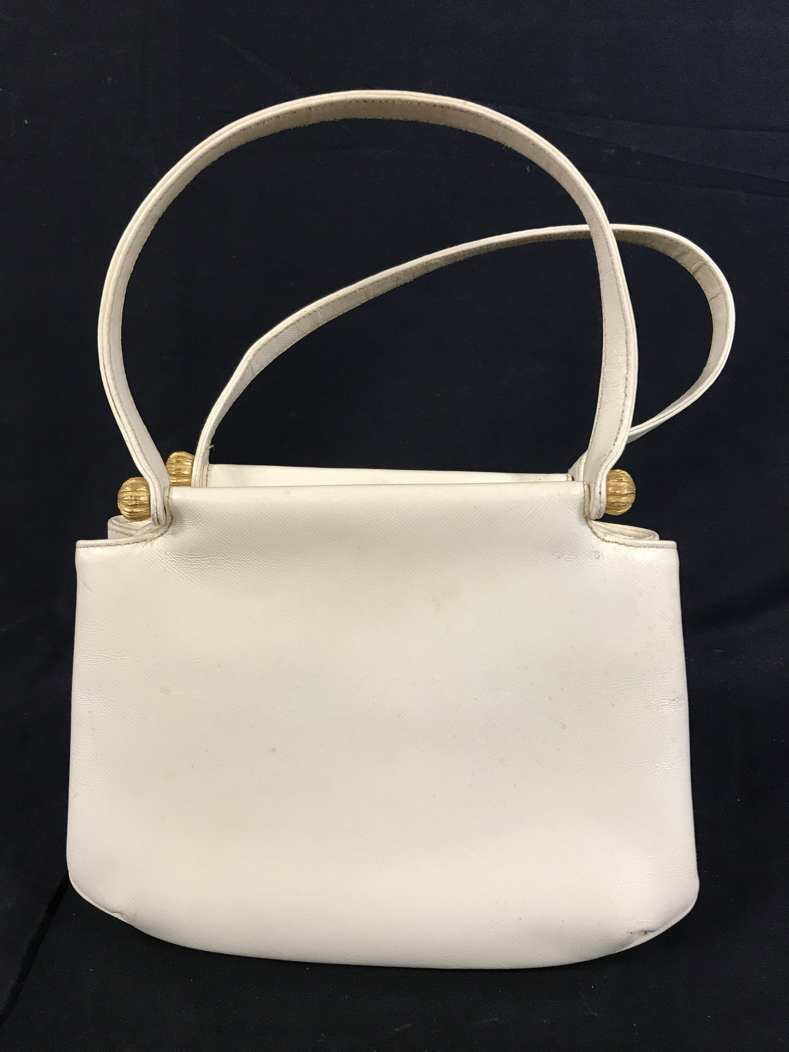 Leather MORRIS MOSKOWITZ Handbag: Interior reads GENUINE LEATHER, MM, MORRIS MOSKOWITZ. Cream colored leather bag, gilt brass clasp secures interior. Measures approx 7 inches H, 8.75 inches W, and a 6 inch drop. Wear is consistent wit