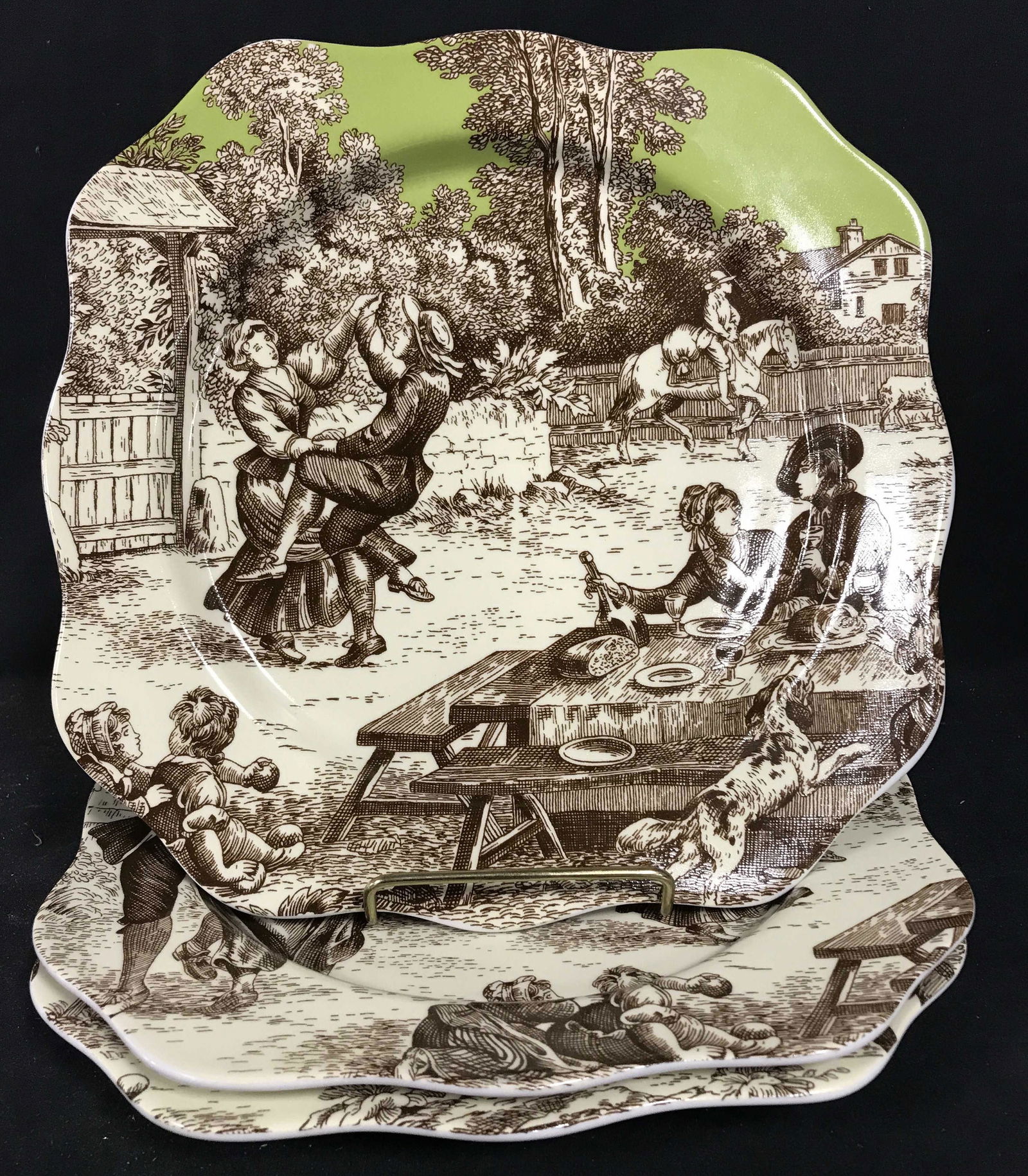 Set 3 ROSANNA Colonial Scene Plates: Set of three ROSSANA plates. Each plate depicts several people in a colonial setting. Plates measure approx 10.5 inches H, and 10.5 inches W. Undersides read as ROSANNA. Wear is consistent with age. C