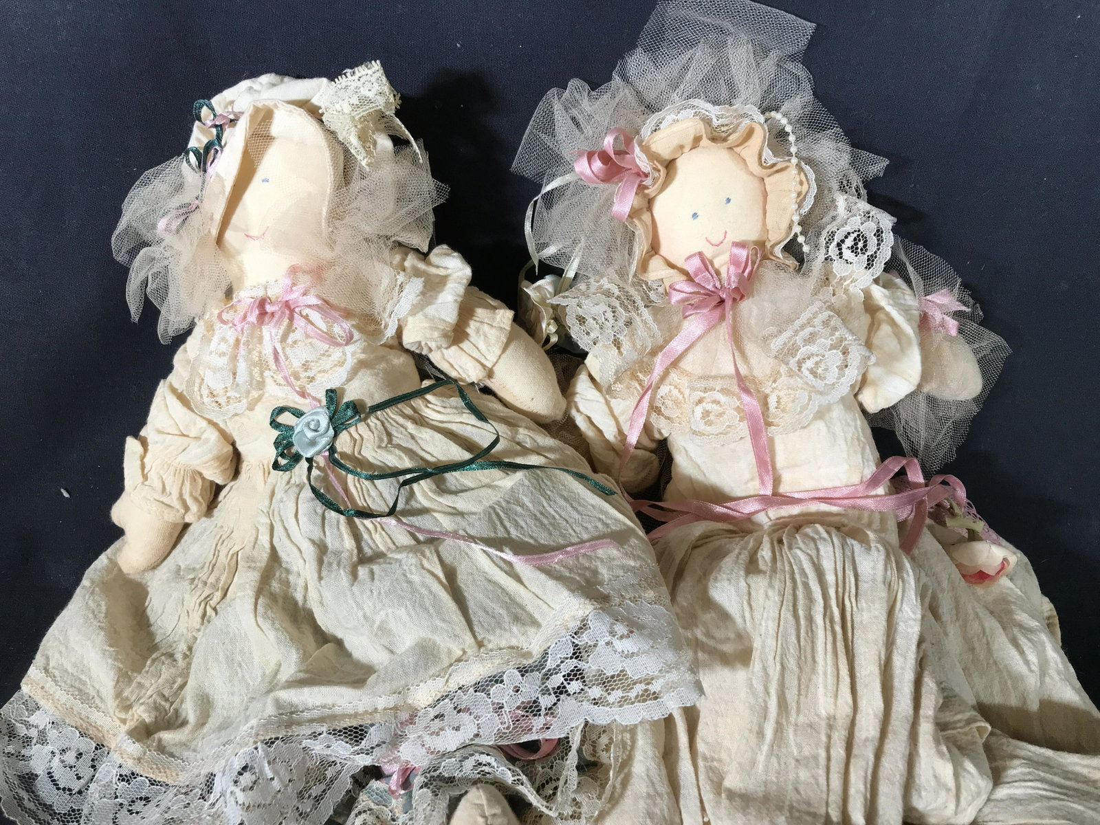 Pair Vintage Victorian Style Handmade Dolls: Pair of vintage, possibly antique, dolls. Dolls are handmade and wearing Victorian style clothing. Largest doll measures approx 14 inches long, 10 inches W, 32 inches long with gown. Wear is consisten