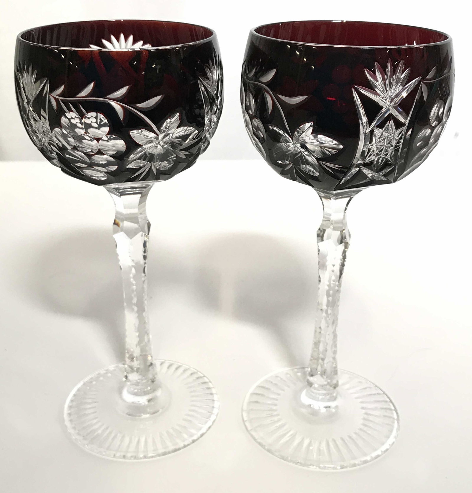 Lot 5 Bohemian Art Glass Wine Glasses: Lot includes 5 glasses. Each appear to possibly be cut crystal. Lot includes 2 green, 2 cranberry, & 1 purple toned glass. Each have clear grape and vine detail. Piece measures approximately 7.5 inche