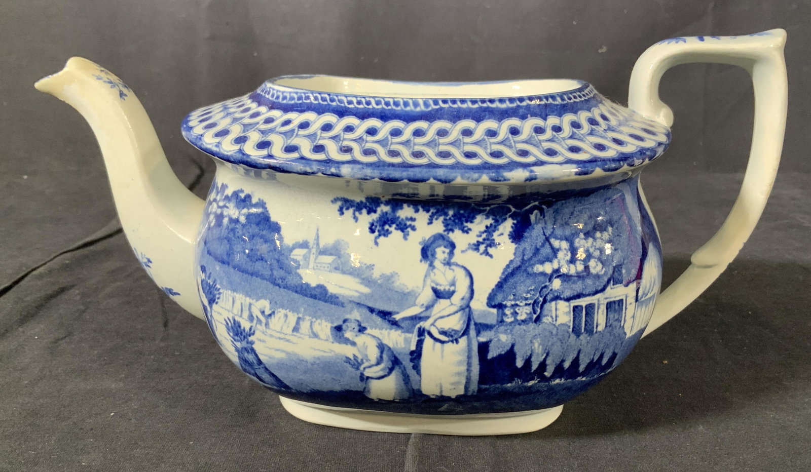 Antique Blue and White Ceramic Teapot: Antique ceramic teapot, no apparent inscriptions or stamps, design features people farming, measures 4 3/4 inches at tallest point x 9 3/4 inches at widest point, missing lid, some minor chips to spou