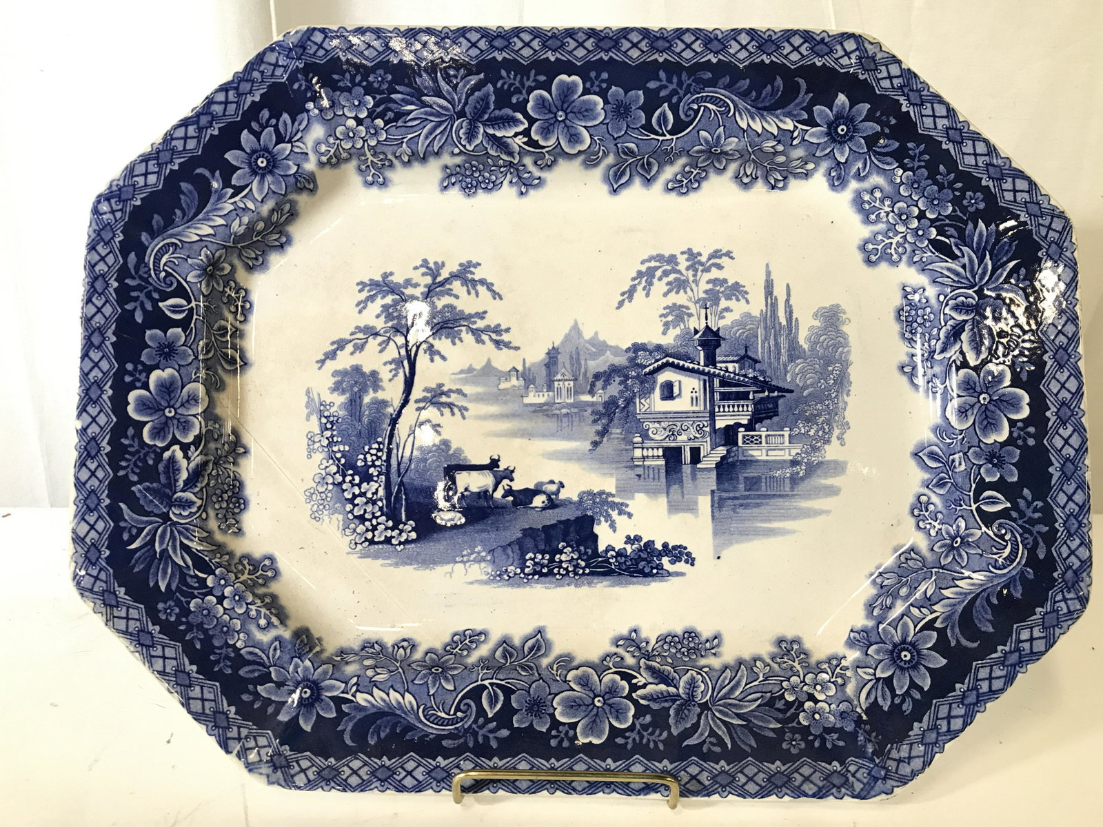 LORRAINE W ADAMS & SONS Porcelain Serving Dish: Underside is marked LORRAINE W ADAMS & SONS IRONSTONE. Piece IS porcelain. Dish is cream toned with blue floral, vine, leaf and landscape detail. Piece measures approximately 16 inches long 12 inches 