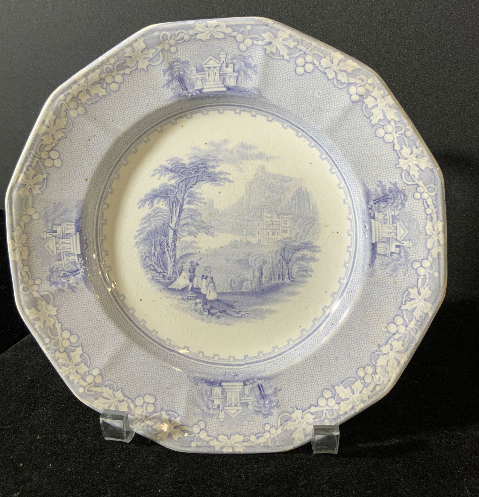 JENNY LIND Signed Antique Porcelain Plate: Blue & white collectible antique porcelain plate. Boarder features berries along a vine and buildings with trees. Center image depicts people, one with a telescope, beneath trees looking toward the bu