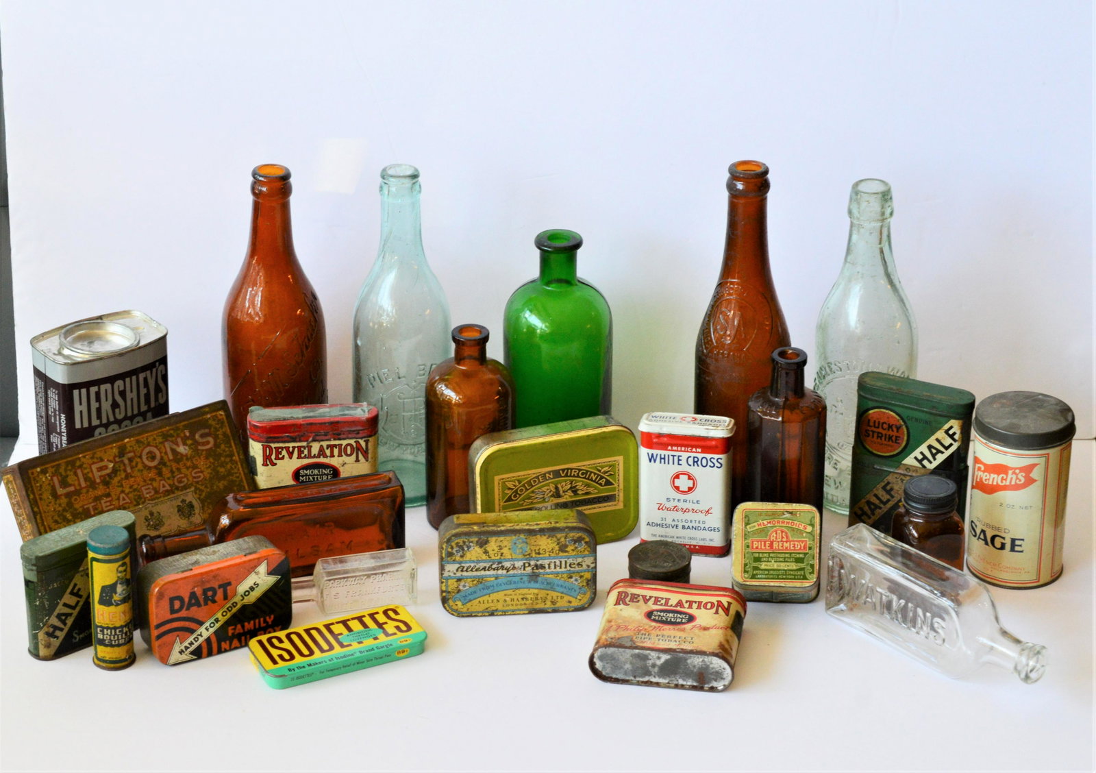 Group Lot Antique Glass Bottles, Vintage tins: Fine Collection of Antique Glass Bottles and Vintage Product Tins. Collection of nine Antique Glass Bottles including Beer, Apothecary and Soda. Vintage Product Tins include, Tobacco, Analgesic, Spice
