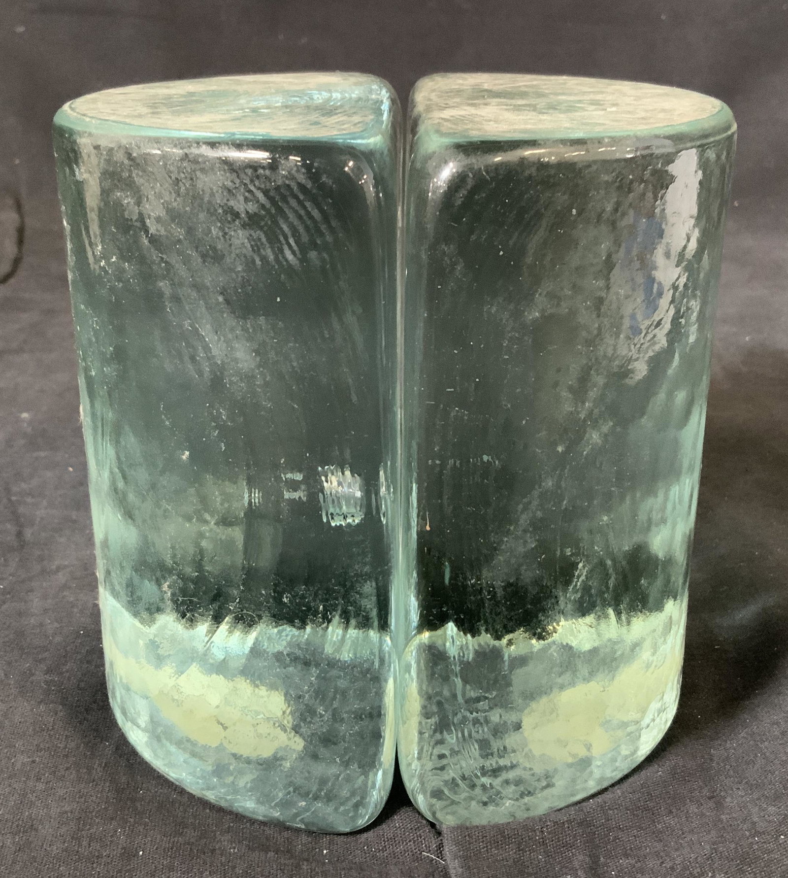 Pair BLENKO Textured Art Glass Bookends: Pair BLENKO Textured Glass Bookends, label to base reads ‘Mirror Mart 314 S County Rd Palm Black, Fla’, measure 5 inches tall x 2 3/8 inches at widest point, heavyweight object, some surface wear 