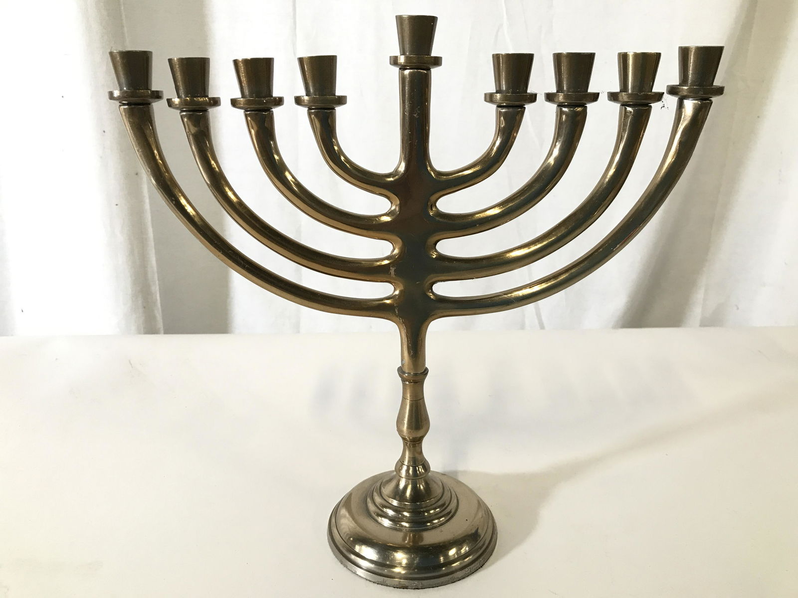 Gold Toned Metal Menorah: Menorah is gold toned and metal. Piece measures approximately 11 inches tall and long 4 inches wide. Menorah, Metal menorah, Judaica menorah, Judaica, Hebraica. ceremonial accessory, home accent, 6
