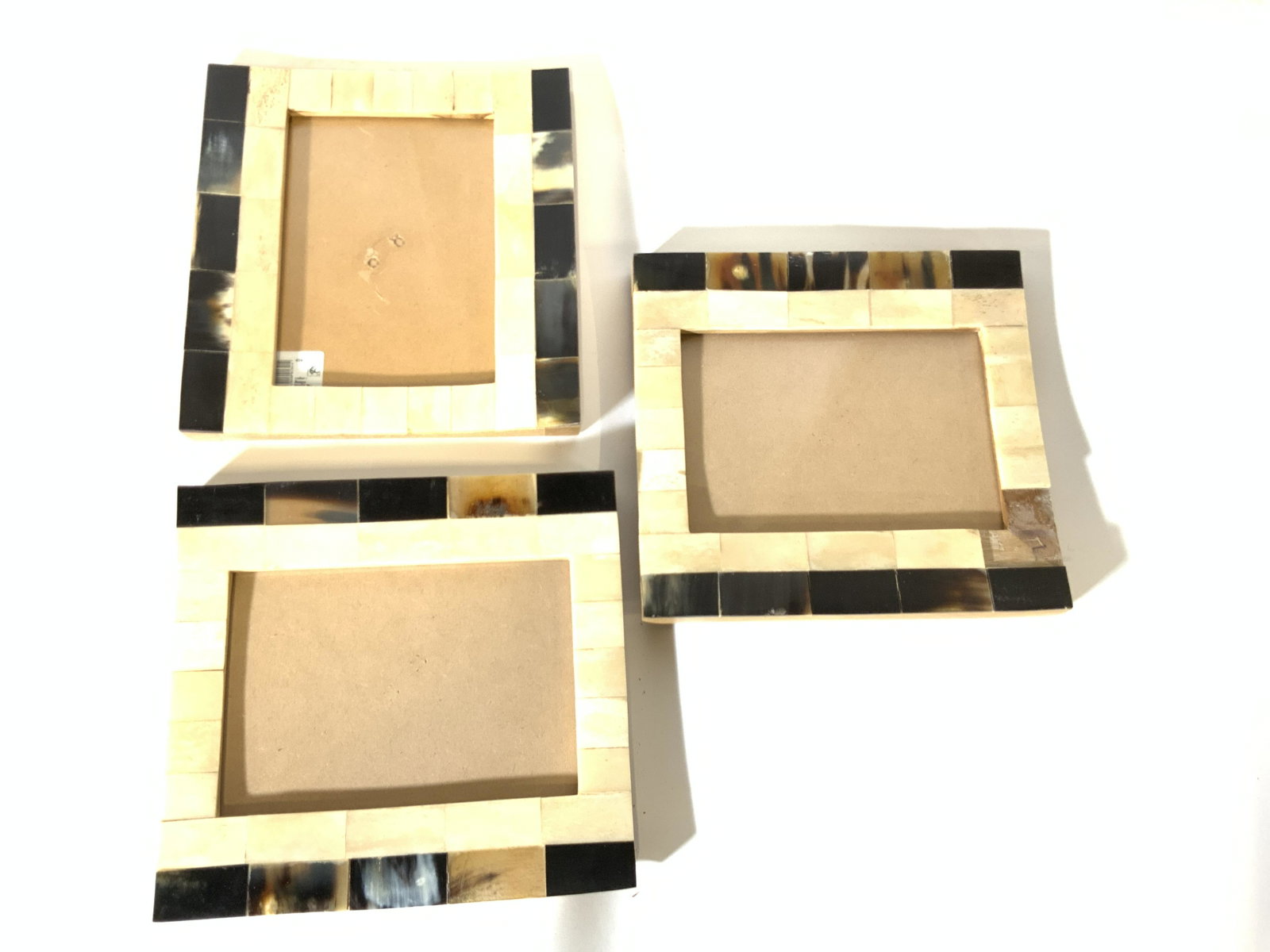 Set 3 EPC Indian 5x7 Picture Frames, Org tag.: Set 3 Indian Picture Frames, label to one frame reads ‘Color: Beige Made in India’, EPC, comprised of composite material set in linear pattern, flanked by darker colored composite chips. Fits 5x 7