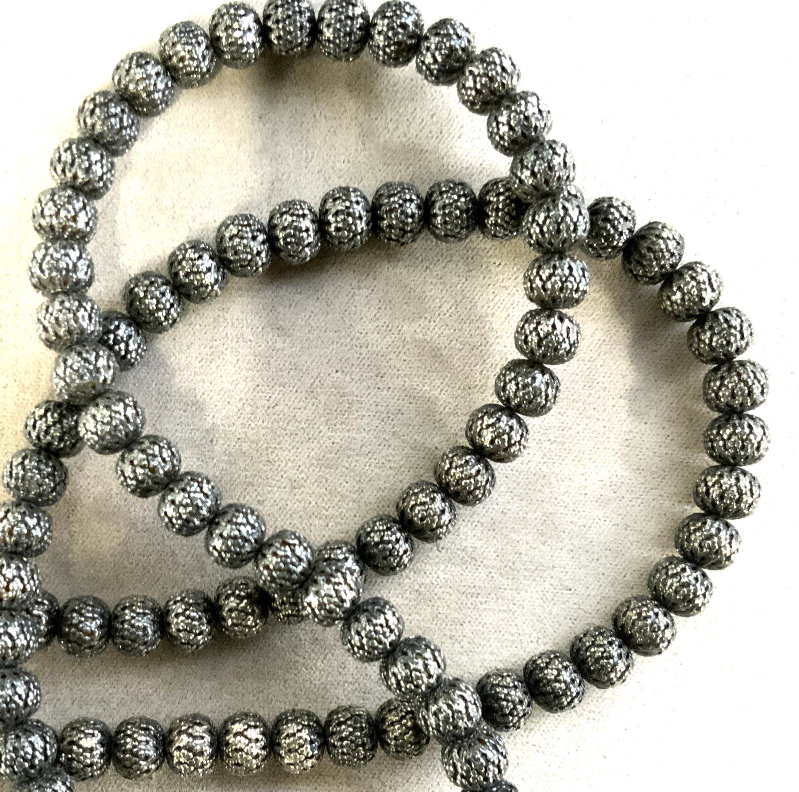 Pierced Metal Beaded Necklace: A contemporary Piece with soft middle eastern pierced pattern on each bead. App 8 mm beaded, marcasite toned, lobster clasp, 26 in. Middle Eastern Contemporary Jewelry, Metal Bead Necklace, Costume Je