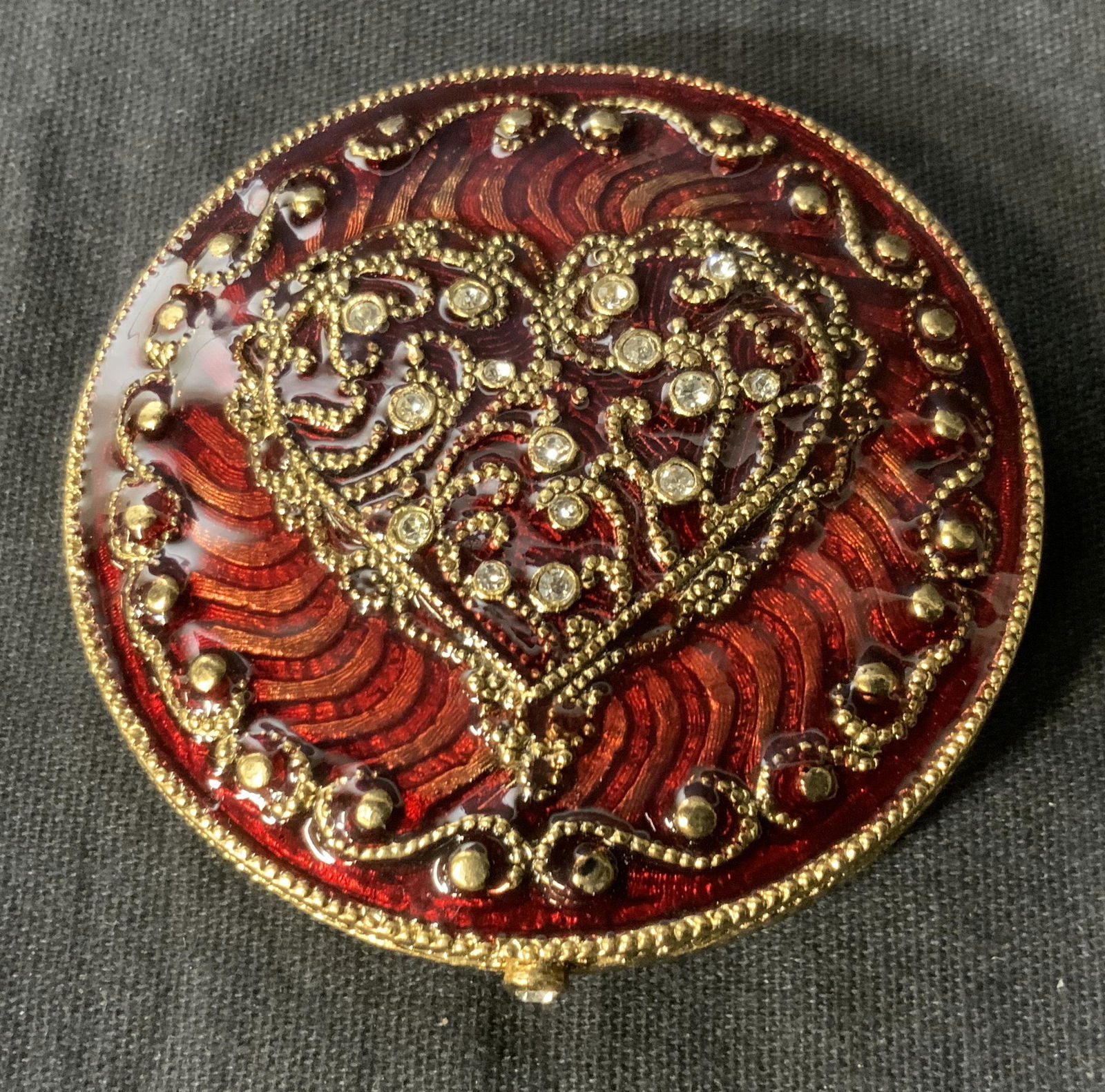 MONET Enameled Compact Mirror: MONET Enameled Compact Mirror, inscription to reverse reads ‘Monet’, bejeweled and enameled heart design, measures 2 1/4 inches in diameter, in good condition, Monet, enamel work, compact, mirror,