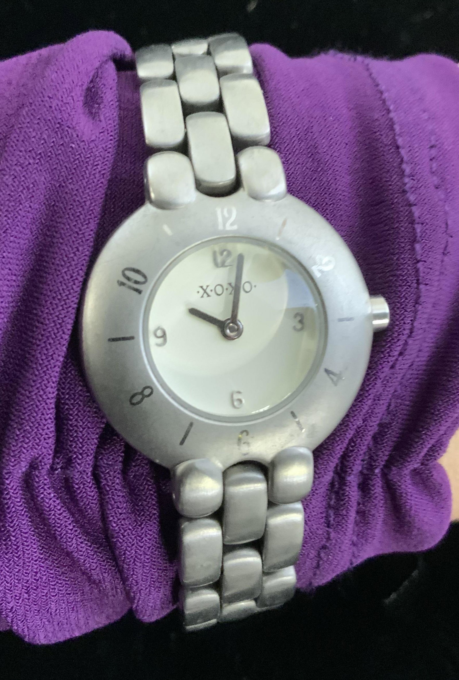 XOXO Signed Japan Movement Wristwatch: Brushed silver toned Metal Link watch, signed XOXO On watch face and clasp. Backside reads xoxo- x876 stainless steel back, 3 ATM water resistant, Japan movement. 7.25 in long. Watch, Designer Watcher