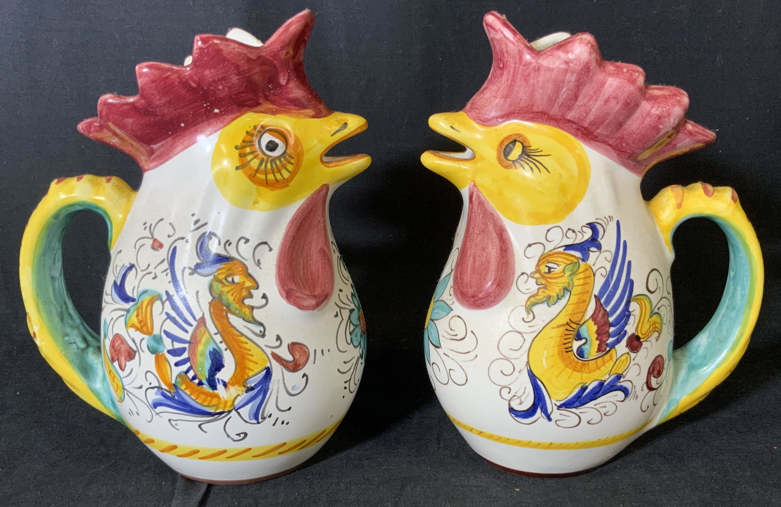 Pair DERUTA Chicken Shaped Pitchers, Italy: Pair DERUTA Chicken Shaped Pitchers, Italy, inscription to base reads ‘Made in Italy”, hand painted design, both measure 8 3/8 inches tall x 6 1/4 inches at widest point, some losses to design but