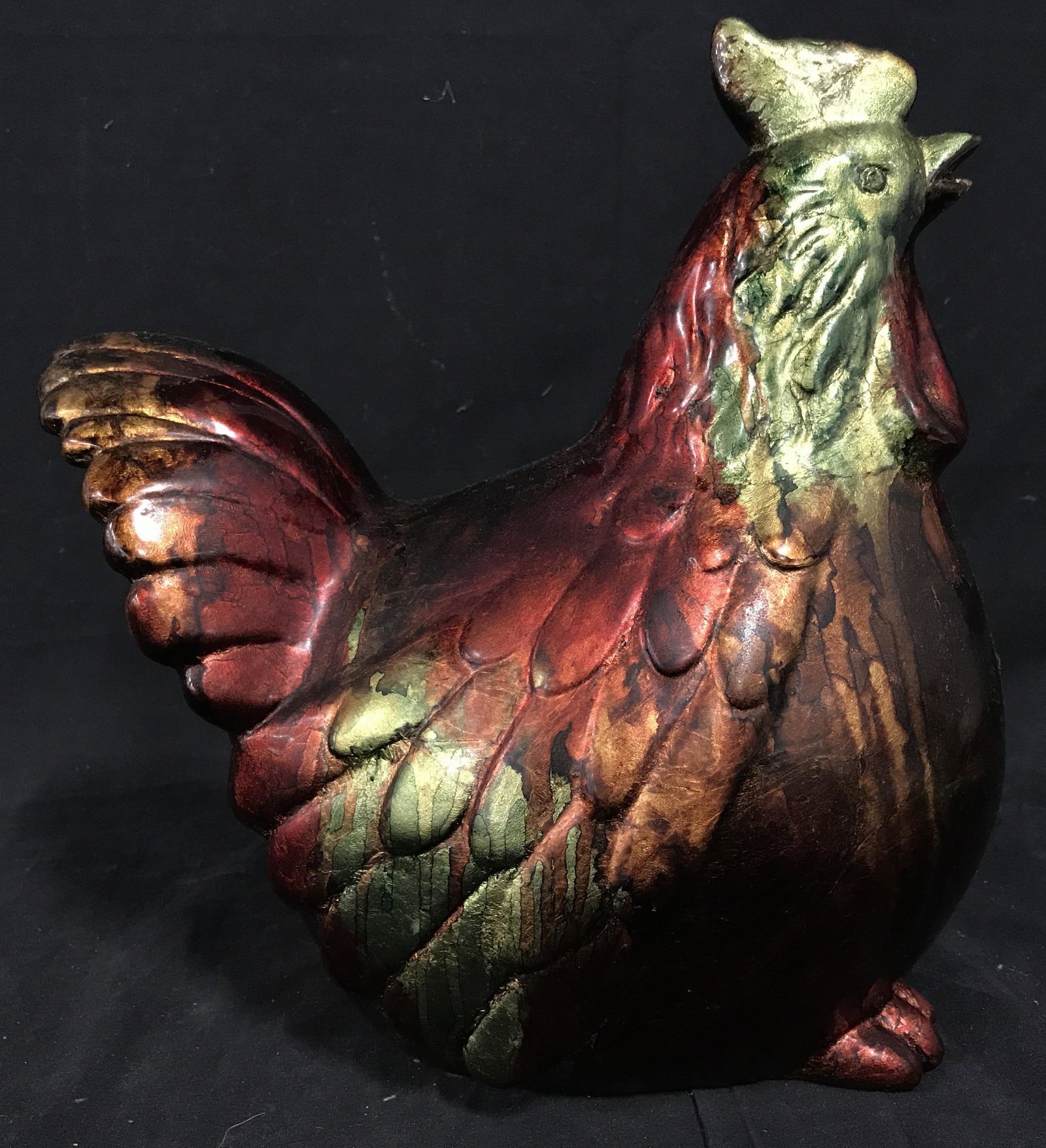 Ceramic Metallic Painted Chicken Figural: Ceramic metallic painted chicken, no apparent signatures or stamps, subject a seated hen with head raised, painted with metallic fall colors such a red brown orange and green, measures 12 inches at ta
