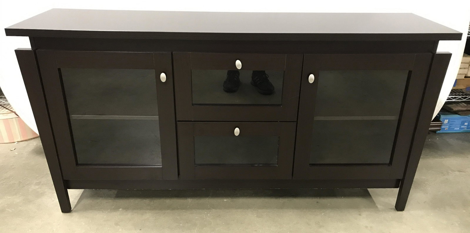 ID INTERNATIONAL INC Wood Sideboard: Wooden sideboard. Two drawers, and two door, each is windows. Label on back reads as ID INTERNATIONAL INC. Measures approx 30 inches H, 60 inches W, and 15.75 inches deep. Wear is consistent with age 