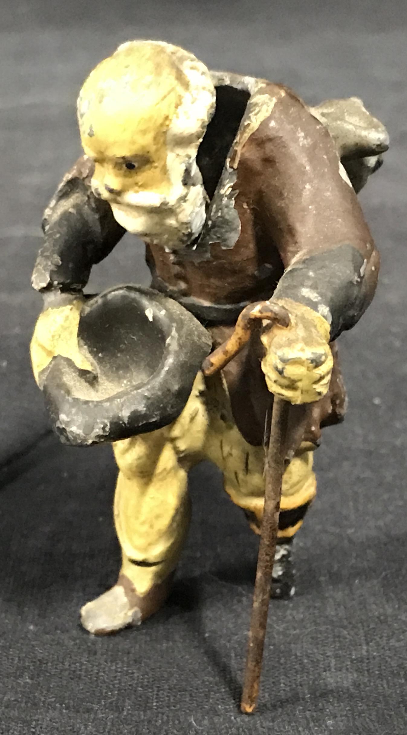 Antique Iron Springy Head Hobo Figure: Antique iron springy Head Hobo Figure, subject depicts an old man with hat in hand and cane in the other with one peg leg, chips and wear to painted surface, measures 3 inches tall, Antique, figure, f