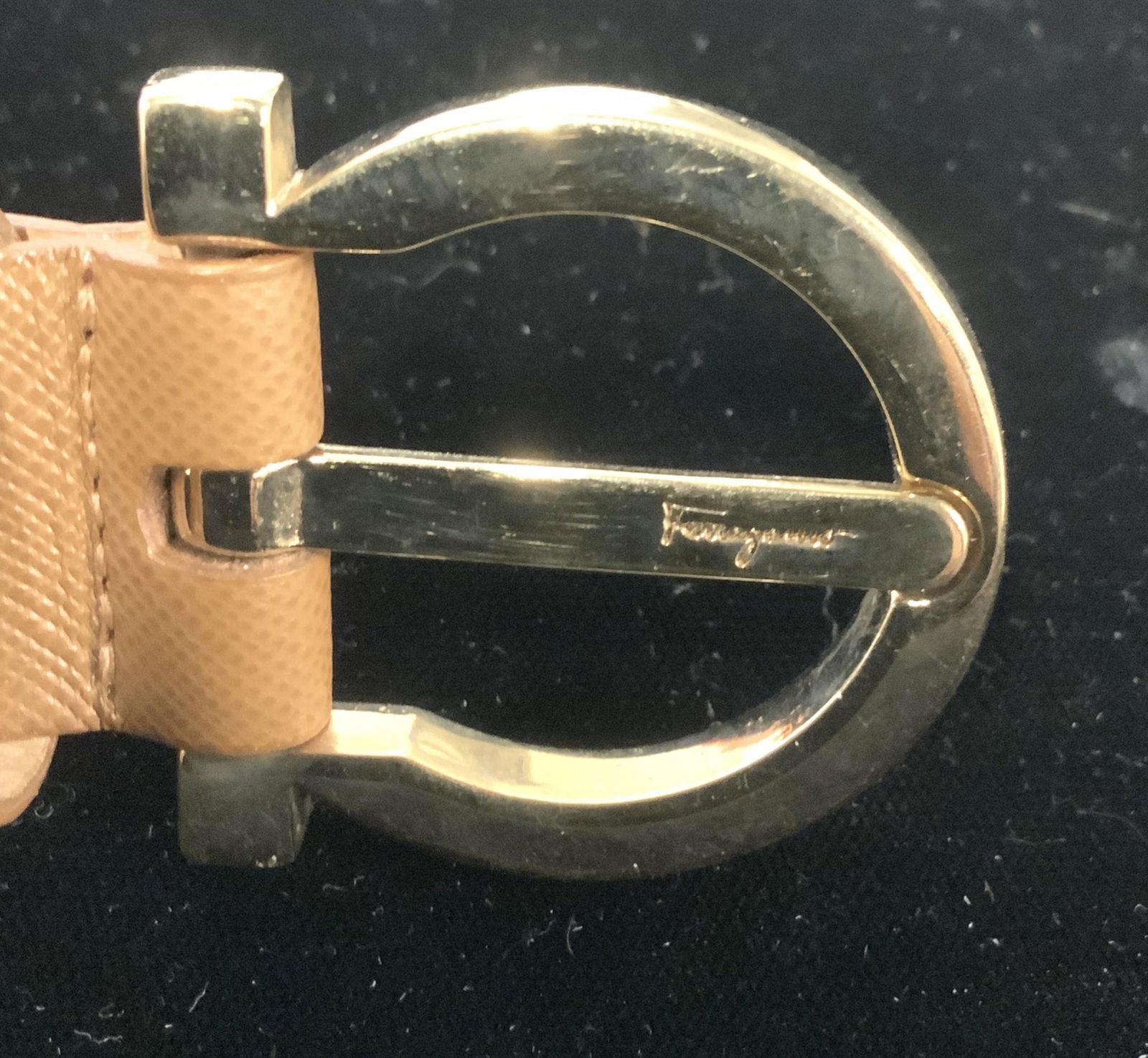 SALVATORE FERRAGAMO Luxury Leather Belt, Italy: Gold toned horseshoe shaped buckle, Impressed Ferragamo brand in center as well as inside belt, reads Salvatore Ferragamo Made in Italy 23 0700. Textured camel colored leather with 3 hole adjustment,