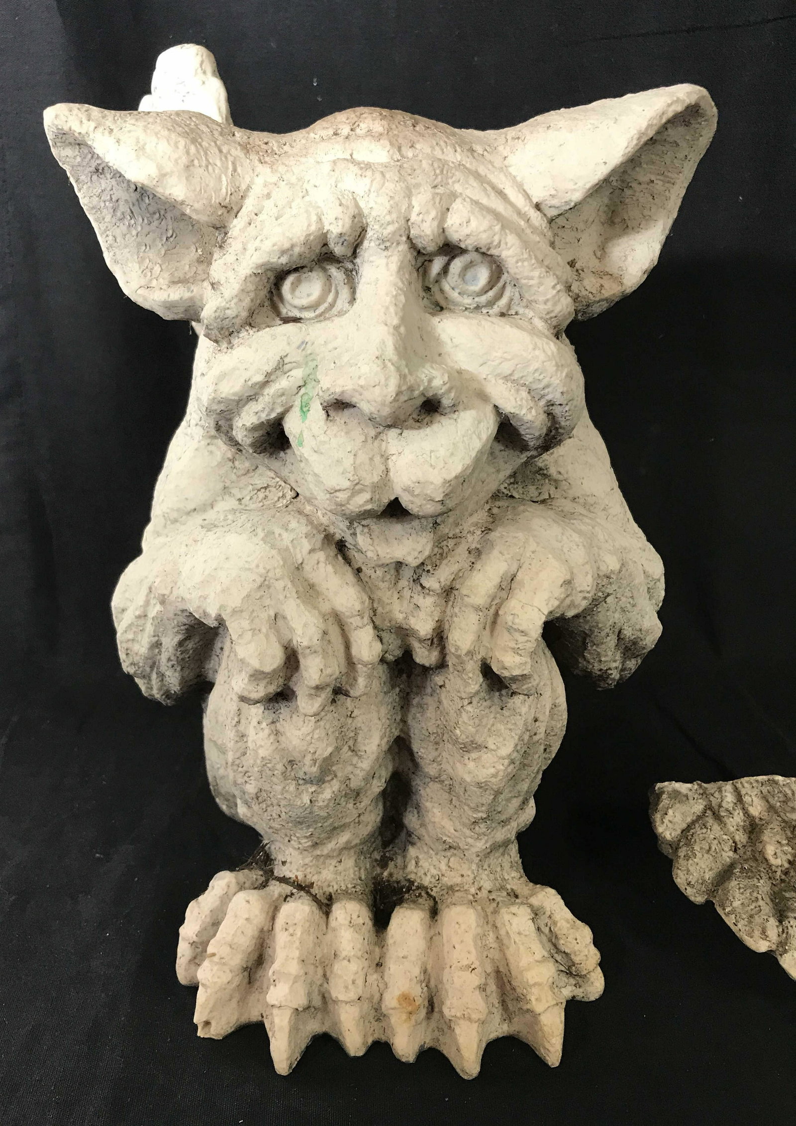 Outdoor Resin Gargoyle Sculpture: Outdoor gargoyle decor, crafted from a composite material, possibly resting. Depicts a stone gargoyle with feathered wings. Measures approx 8.5 inches W. Wear is consistent with age and exposure, wing