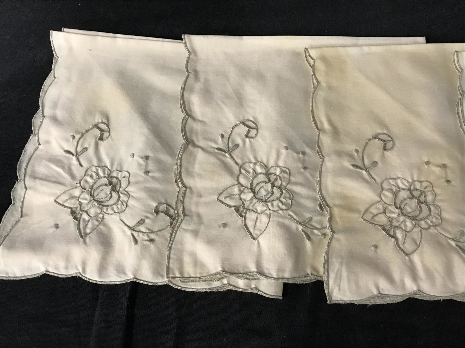 Set 17 Embroidered Table Linens: Set 17 embroidered table linens. Linens are cream toned with beige embroidery, embroidery forms a floral and plant like pattern. Largest pieces measure approx 18.5 inches W, 12 inches long. Wear is co