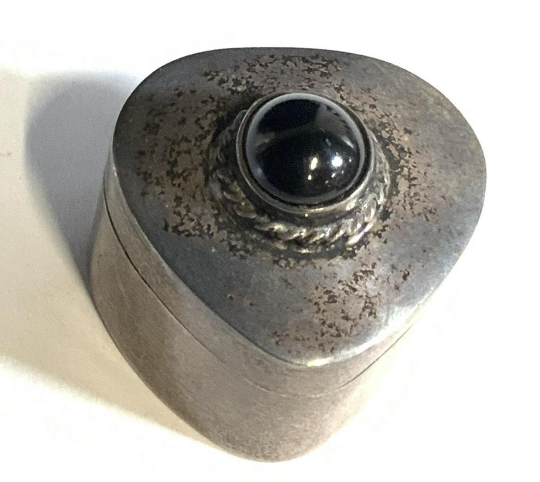 Sterling Silver Pill Box W. Black Cabochon, Mexico: Vintage triangular sterling silver pill box with a black costume cabochon on the lid. Box has a hinged closure. Interior marked: T9-4 925 Mex. Weight .61 ozt. Approx. Height 1 in. Approx. Width 1 in.