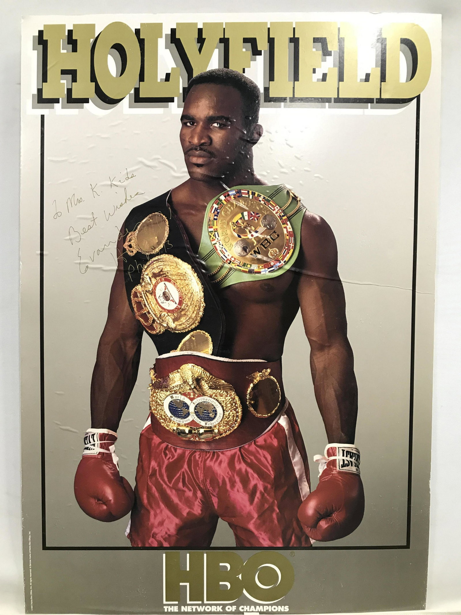 Signed EVANDER HOLYFIELD HBO Poster: Poster signature reads EVANDER HOLYFIELD. Poster depicts champion boxer EVANDER Holyfield. Lower area reads HBO NETWORK OF CHAMPIONS. Piece measures approximately 41 inches tall 27 inches wide. EVANDE