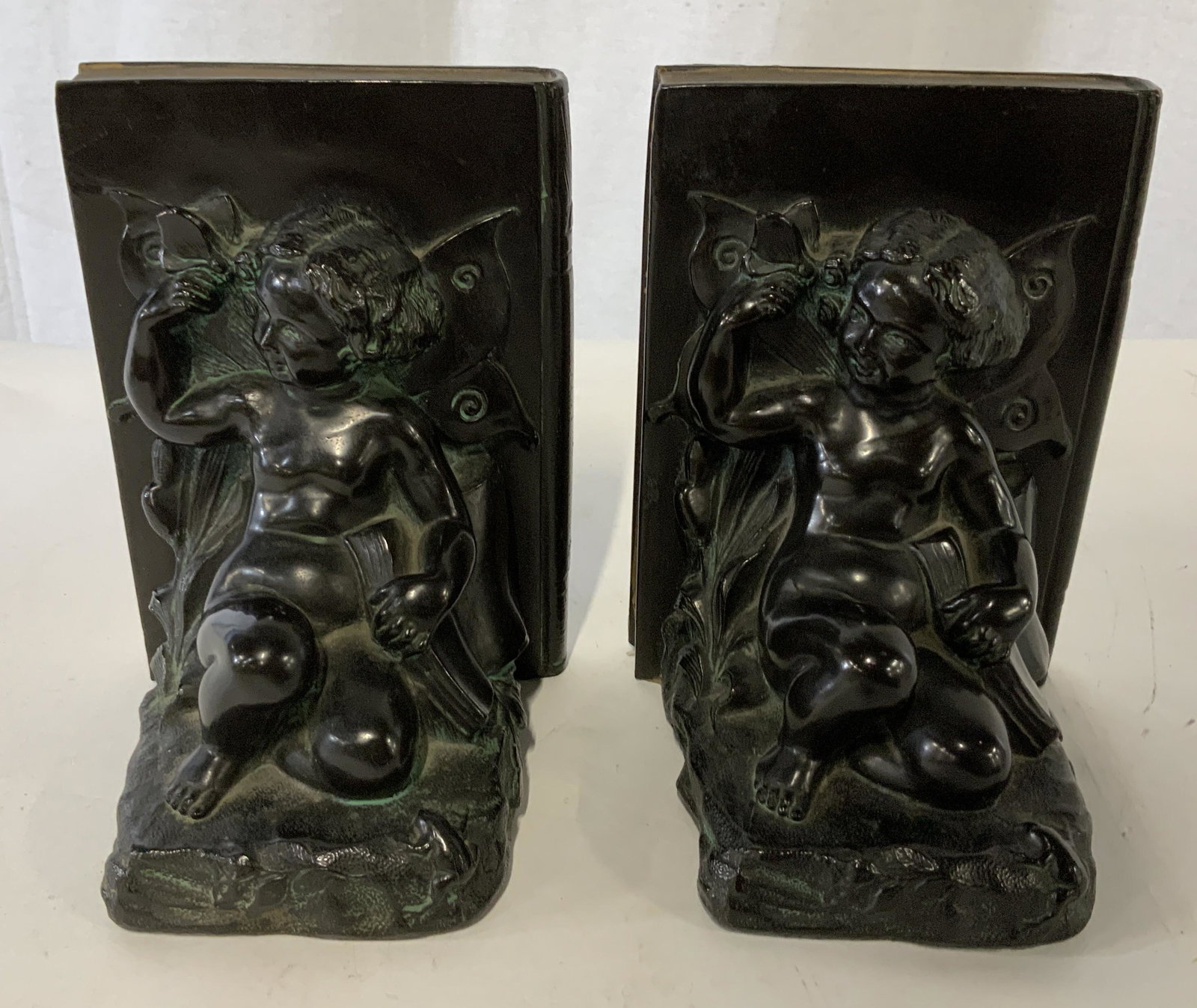 Pair RONSON Cherub Metal Bookends: Pair RONSON Cherub Metal Bookends, no apparent inscriptions or stamps, two seated figures with wings, both measure 6 1/4 inches tall x 4 1/2 inches at widest point, some surface wear but overall in go