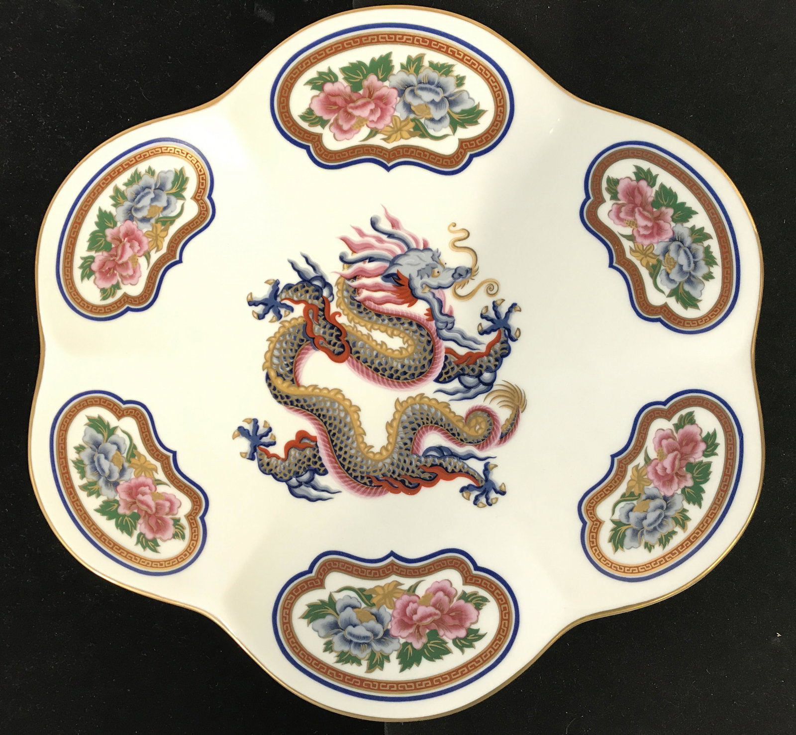 ELIZABETH ARDEN CHINOISERIE COLLECTION Plate: Underside is marked ELIZABETH ARDEN CHINOISERIE COLLECTION. Plate has intricate detail including depiction of dragon, and multi toned floral, leaf and geometric detail. Piece measures approximately 11
