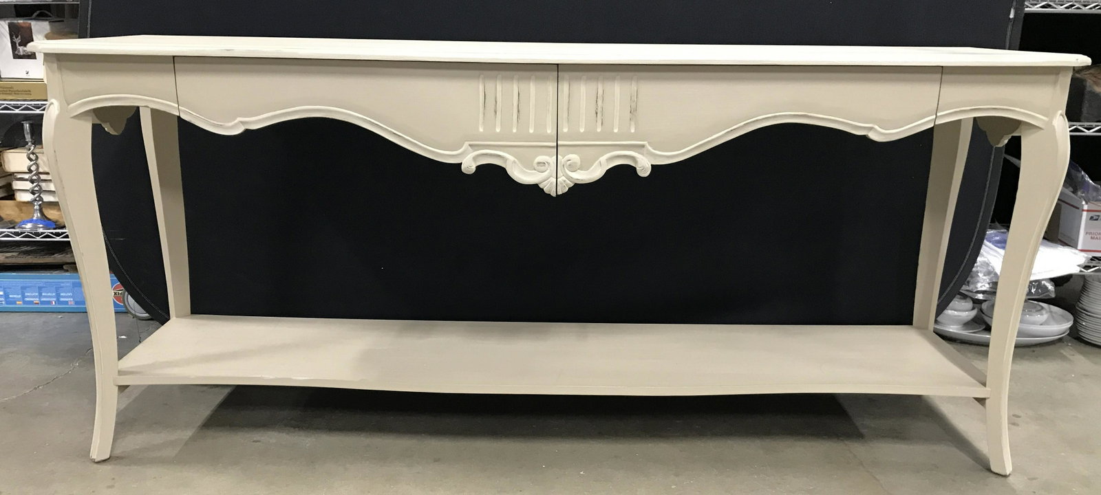 Tan Toned Wooden Console Table W Drawers: Console table is tan toned and wooden. Piece contains 2 drawers which have carved S curve detail. Legs have board stretcher in between. Piece measures approximately 75 Inches long 32 inches tall 20 in