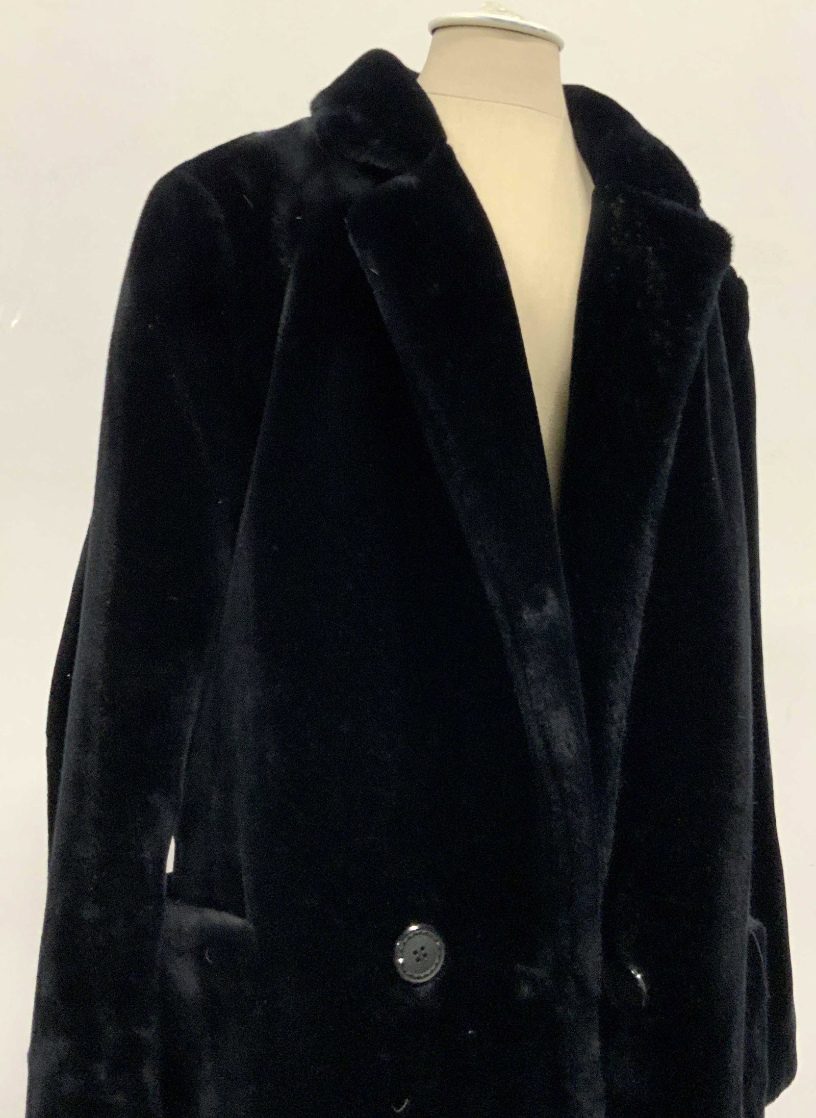 Vintage Plush Long Faux Fur Coat: Long black faux fur coat. Two exterior side pockets. Back fastener with button closure. Button closures along the front as well. Fully lined. Good vintage condition, needs cleaning. Interior Collar ta