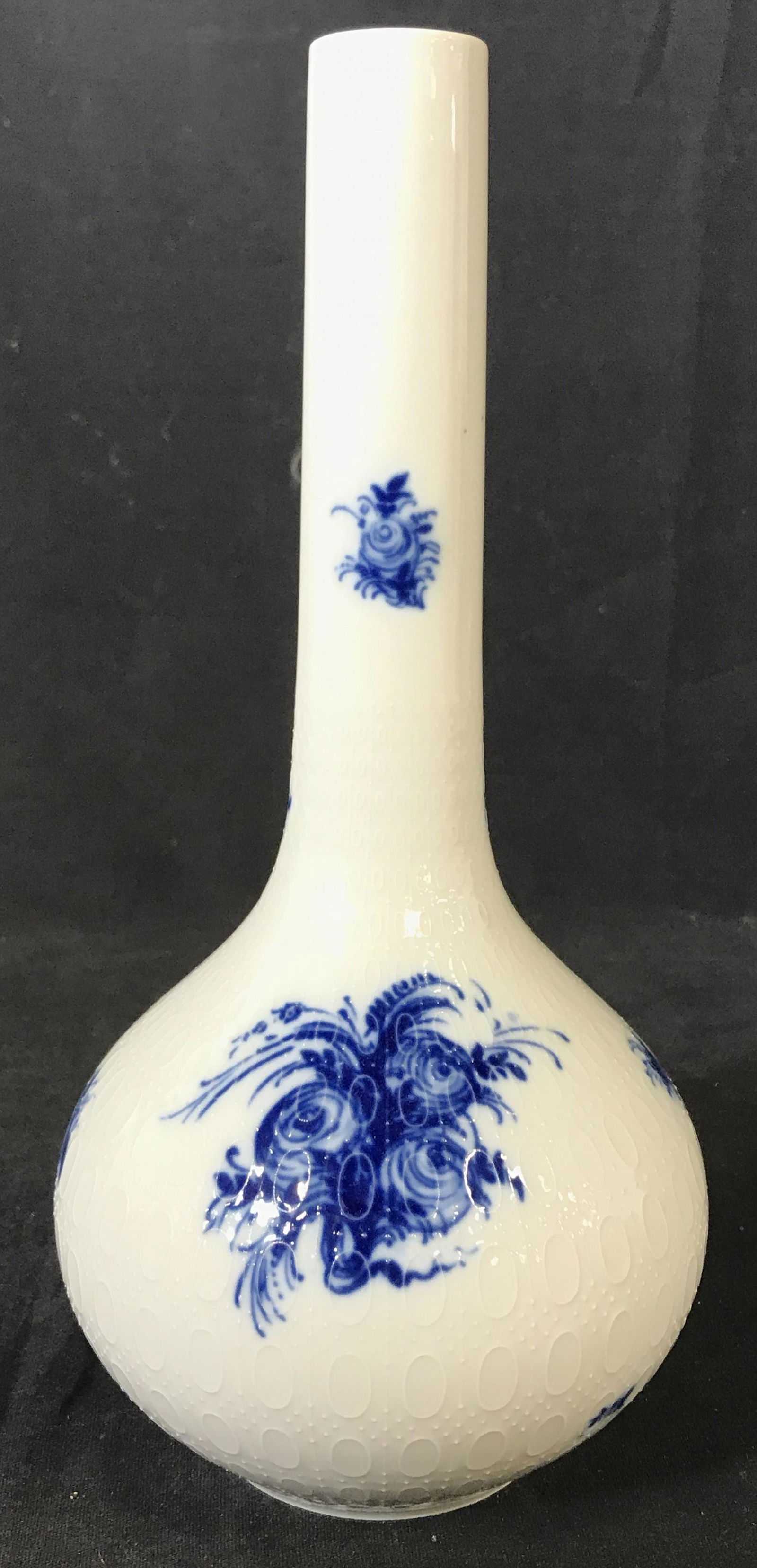 BJORN WINBLAD ROSENTHAL Porcelain Vase: Underside of vase is marked ROSENTHAL STUDIO LINIE GERMANY BJORN WINBLAD. PIECE is white with blue toned floral and leaf detail. Piece has beveled geometric detailed pattern around most of Vase. Piece