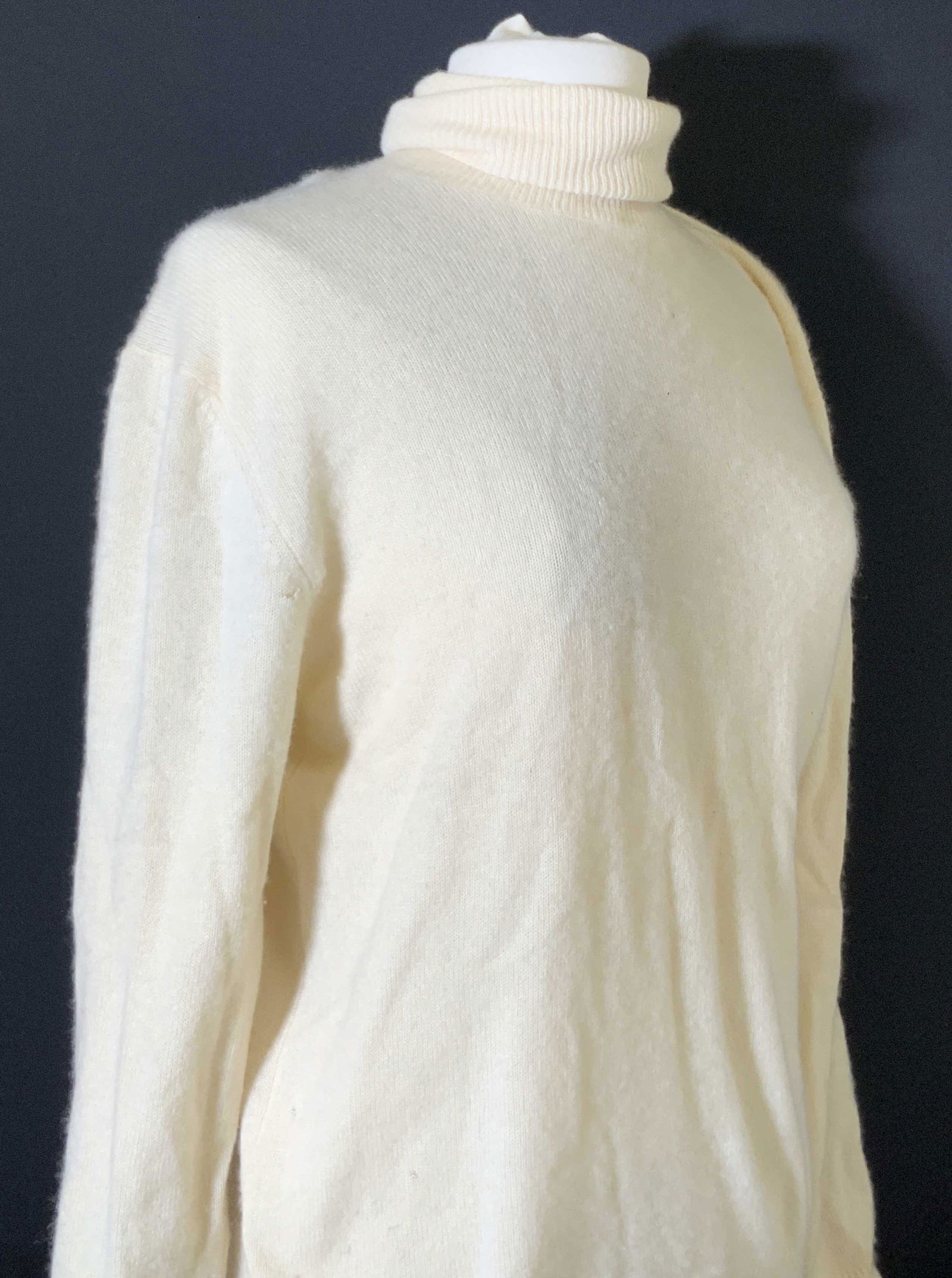 DONNA KAREN New York Cream Cashmere Turtleneck: Cream colored turtleneck sweater. Interior tags read: 100% Cashmere. DKNY, DONNA KAREN NEW YORK. Size approx. Medium. Small holes, some fabric pulling. Cashmere sweater, turtleneck sweater, DKNY, Donn