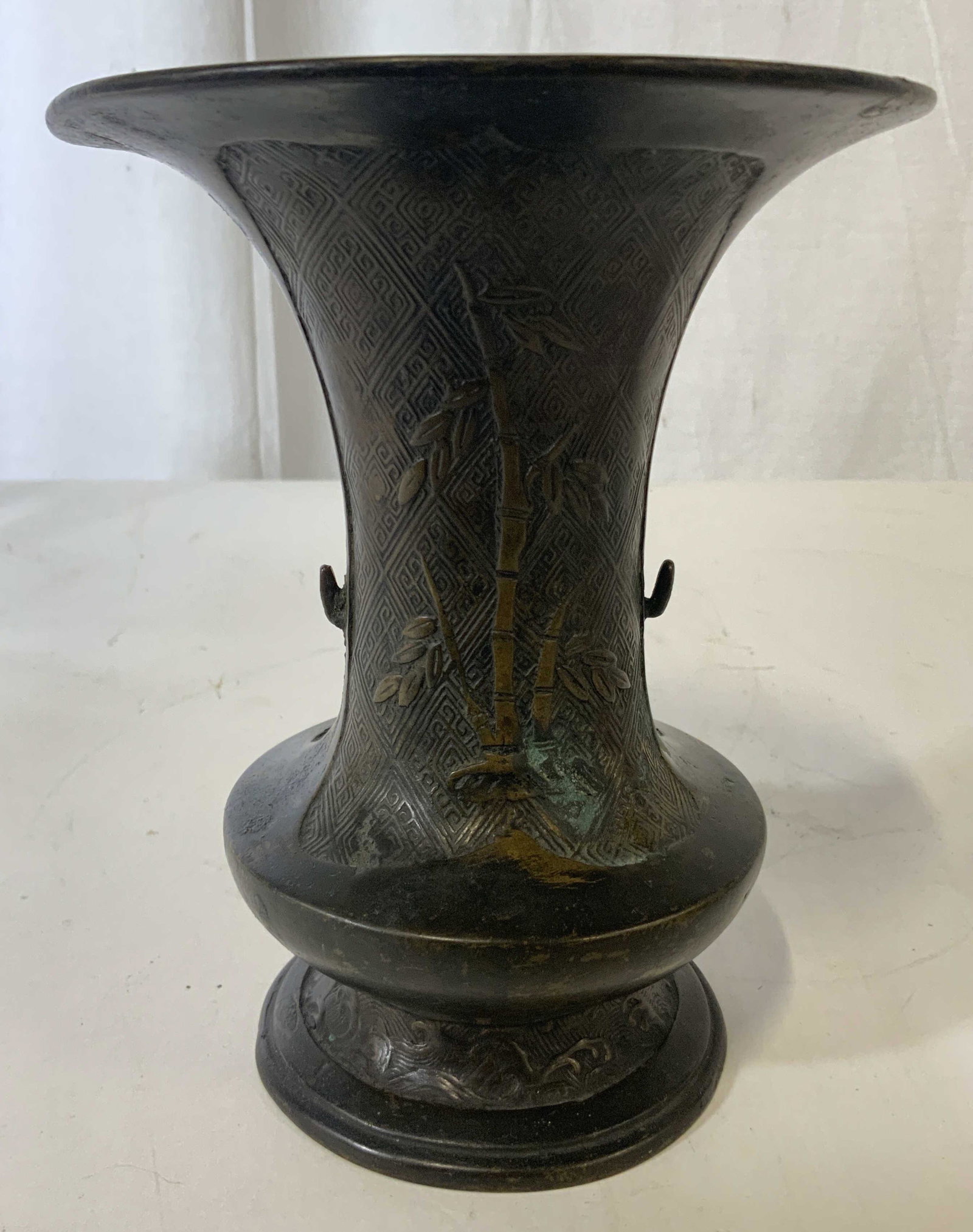 Vintage Pedestaled Bronze Toned Vase Vessel: Vessel is bronze toned possibly genuine bronze. Piece is pedestaled. Vessel has beveled bamboo, leaf & floral detail. Piece is vintage possibly antique. Vessel, vase, decorative arts, tableware, plant