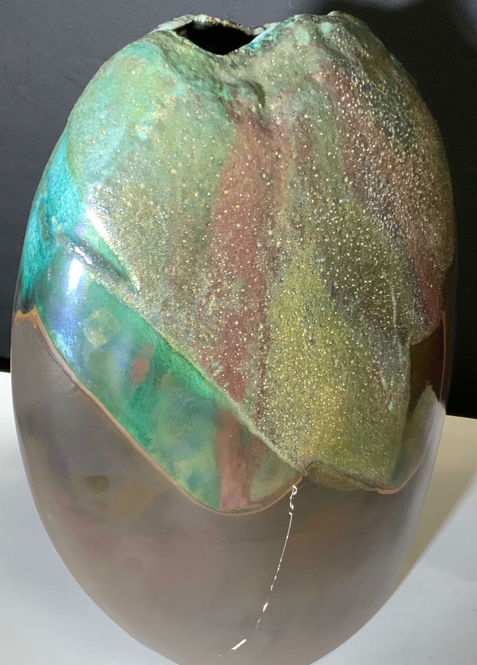 Signed TONY EVANS RAKU Pottery Floor Vase: Late 20th century Tony Evans Raku floor vase. Brown with washes of greens, blues, and purples. Composite pottery. Surface has textured and smooth areas. Lustrous in some areas. Signed and number: EVAN