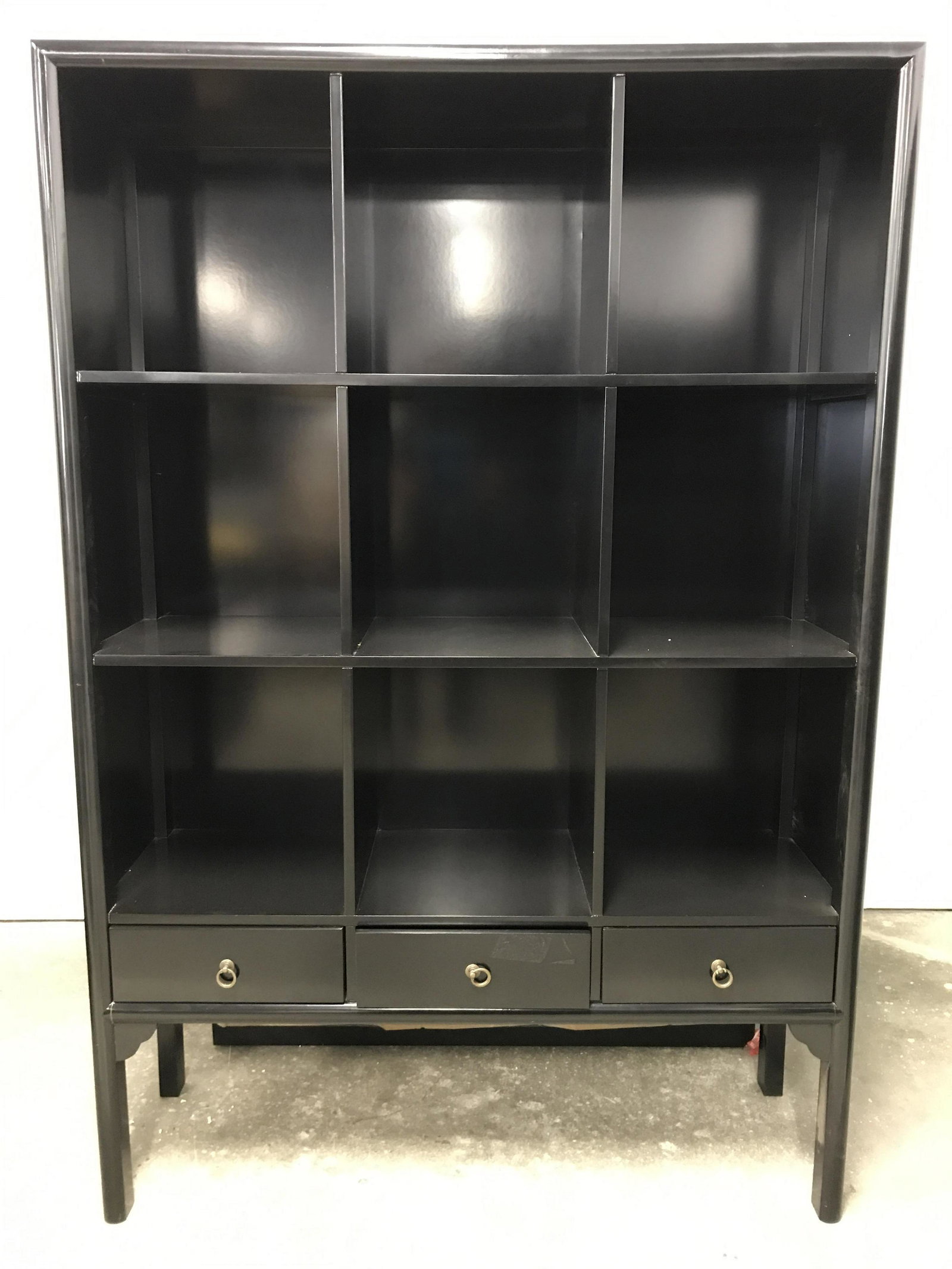 Vintage Wooden Lacquered Shelves: Wooden shelf display case. 9 shelves, three drawers, each drawer has a brass drawer pull. Black lacquered finish. Measures approx 76.75 inches H, 52 inches W, and 16.5 inches deep. Wear is consistent 