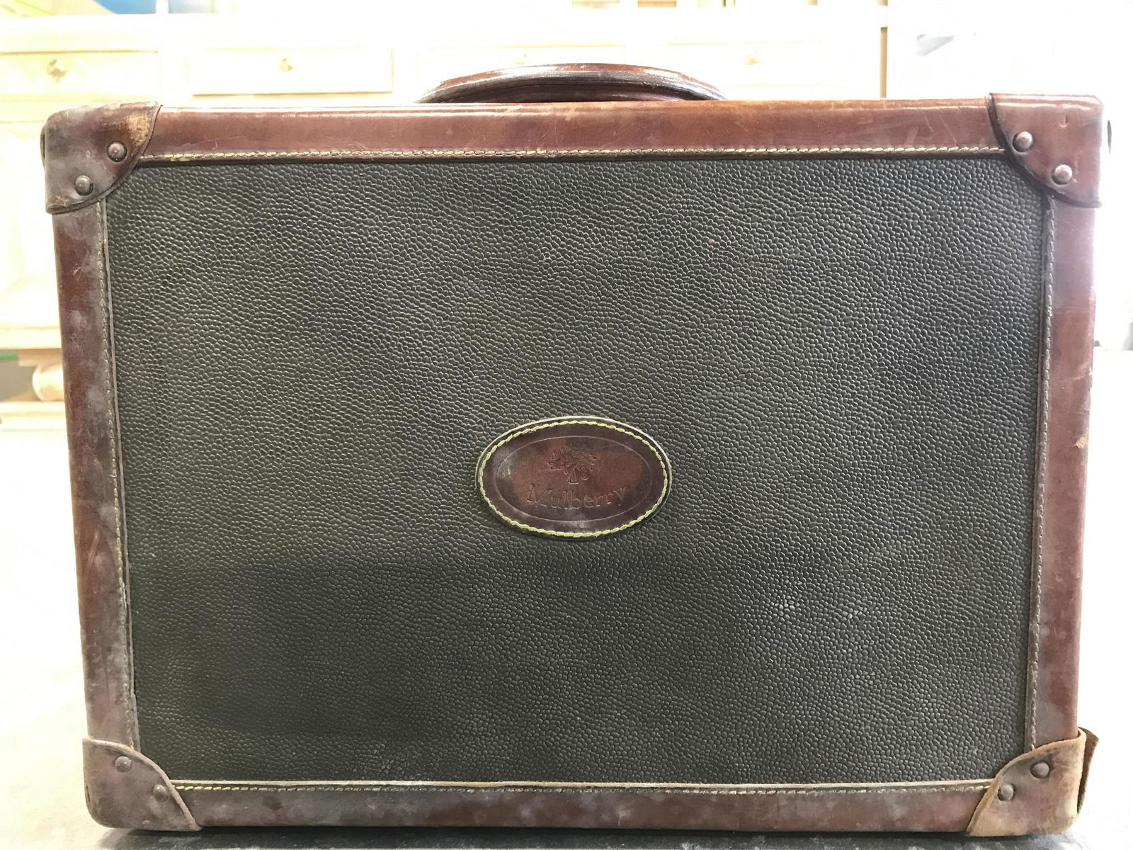 MULBERRY Vintage Leather Suitcase: Suitcase is Marked MULBERRY. Piece is chocolate toned with mahogany toned leather detail at edges. Piece measures approximately 19 inches long 17 inches tall 6 inches deep. Suitcase, vintage suitcase,