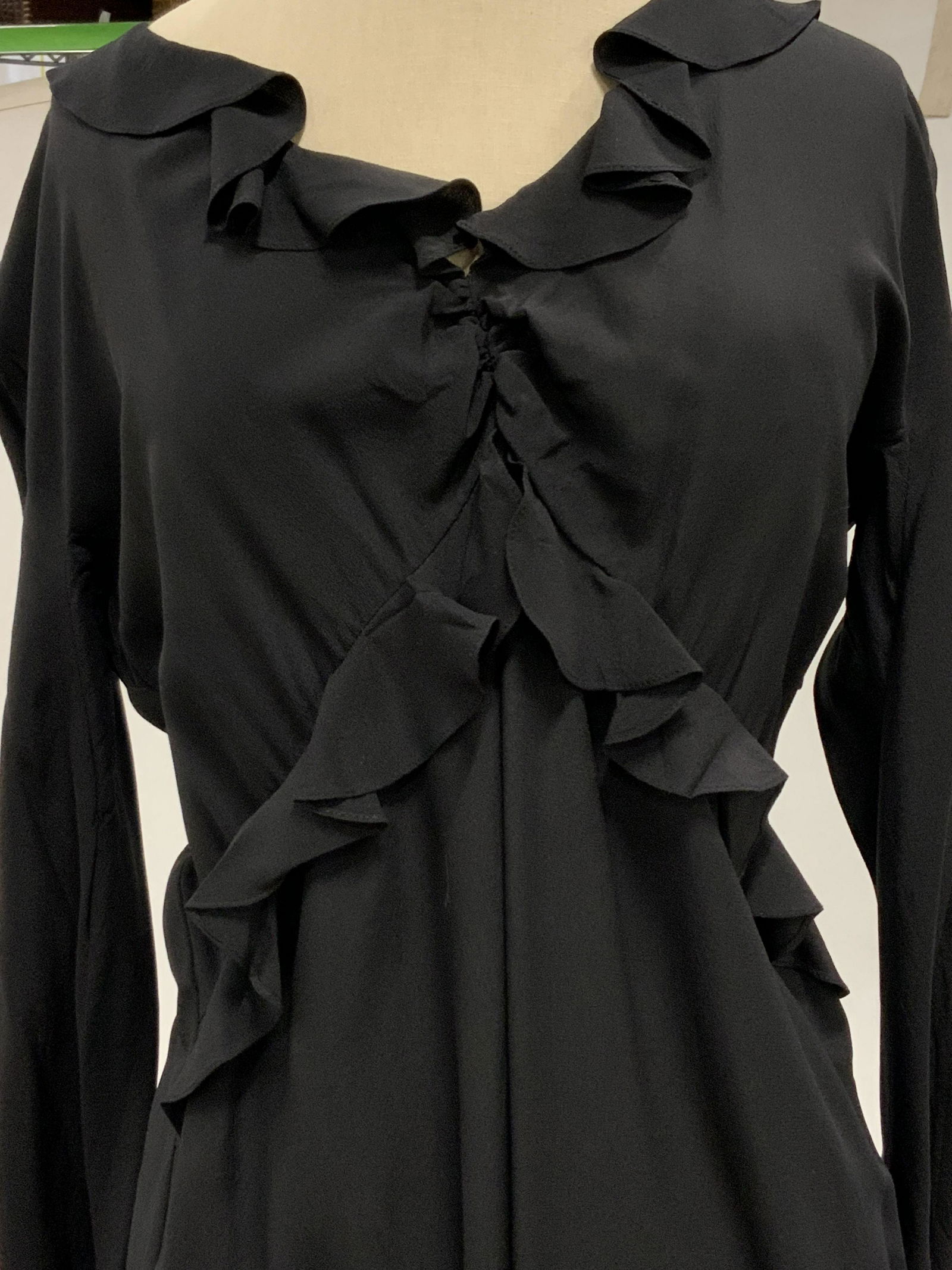 Designer GUCCI Black Silk Dress w/ Original Tags: Black dress with ruffled details. Close to knee length. Black side zipper. Comes with tags and GUCCI dust bag that reads: Gucci. Possibly never worn. Interior tag reads: Gucci, 42. Silk. Length approx