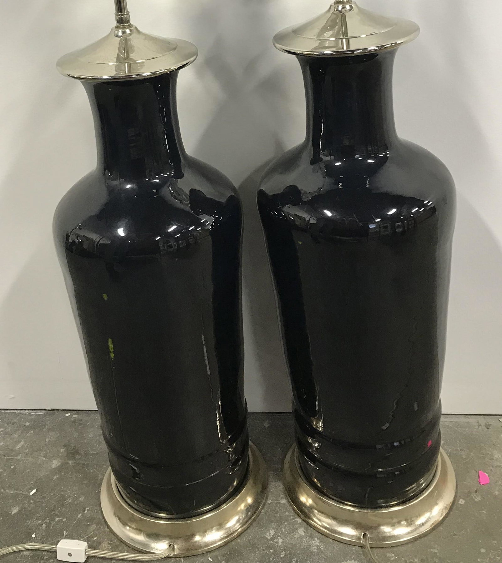 Pair CHRISTOPHER SPITZMILLER Ceramic Lamps: Pair Tabletop Lamps. Lamps are crafted from glazed ceramic. Colored in a deep black pearl finish. Double socket clusters are nickel. Lamps are by designer CHRISTOPHER SPITZMILLER. Each measures approx