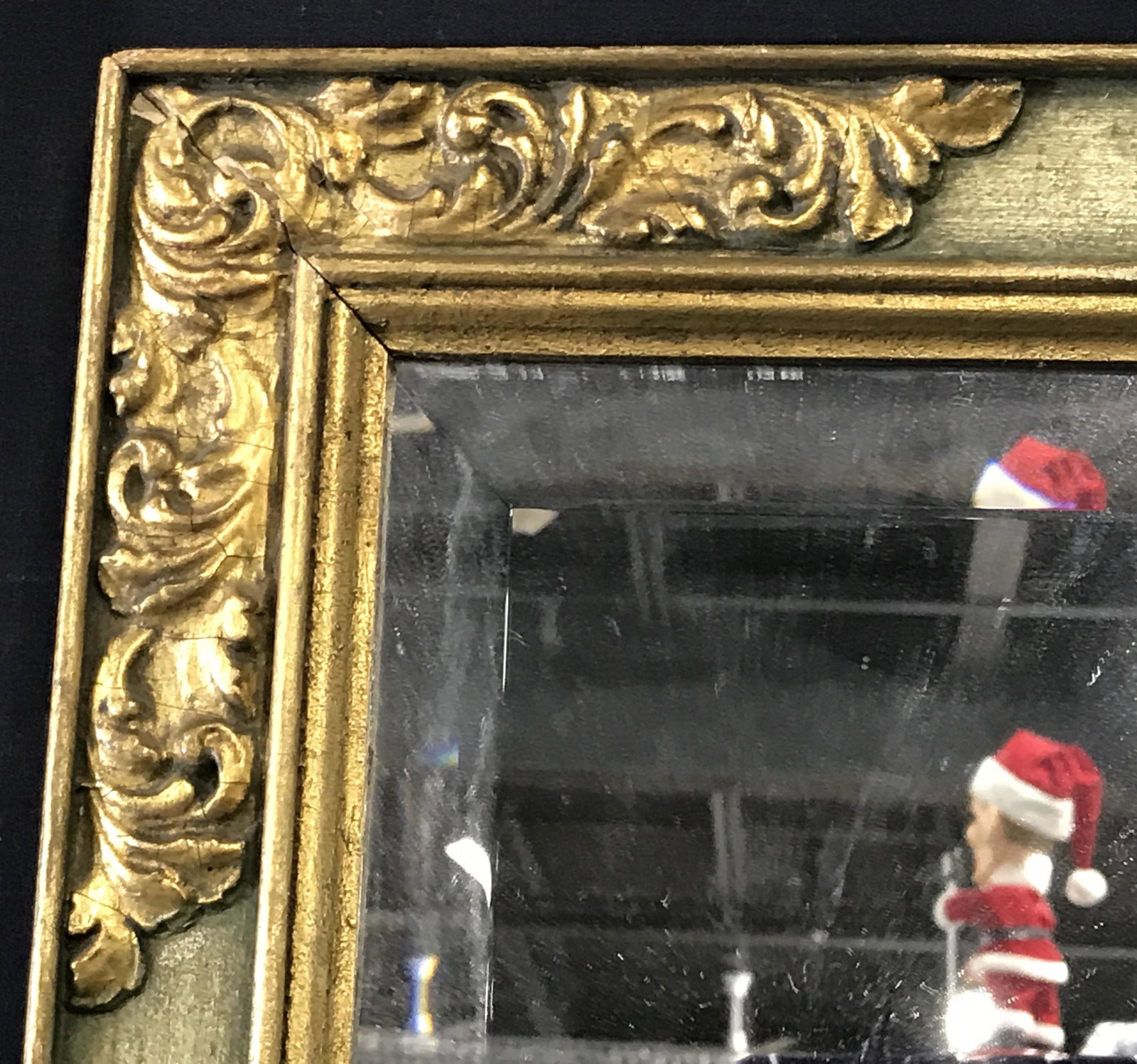 Antique Green & Gilt Framed Beveled Edge Mirror: Antique green and gilt framed beveled Edge mirror, hand carved mirror with acanthus leave designs gilt to each of the corners of the frame, some chips to frame, label to reverse reads ‘Catherine Syl